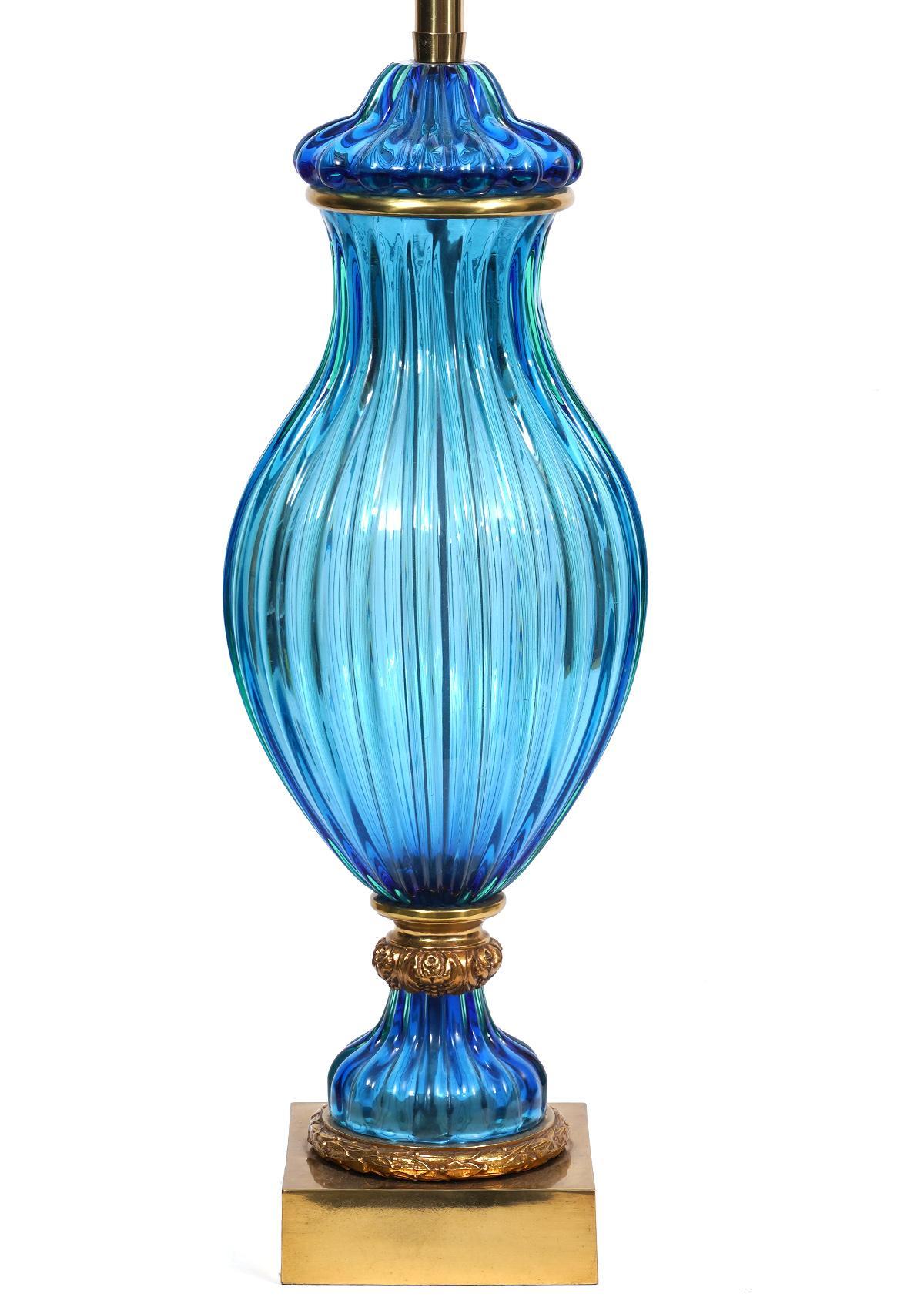 Pair of large blue fluted Murano glass lamps, attributed to Seguso (glass portion), manufactured by Marbro, USA, circa 1960s, signed. The lamps have polished brass hardware atop polished brass square bases. Both lamps feature the original Marbro