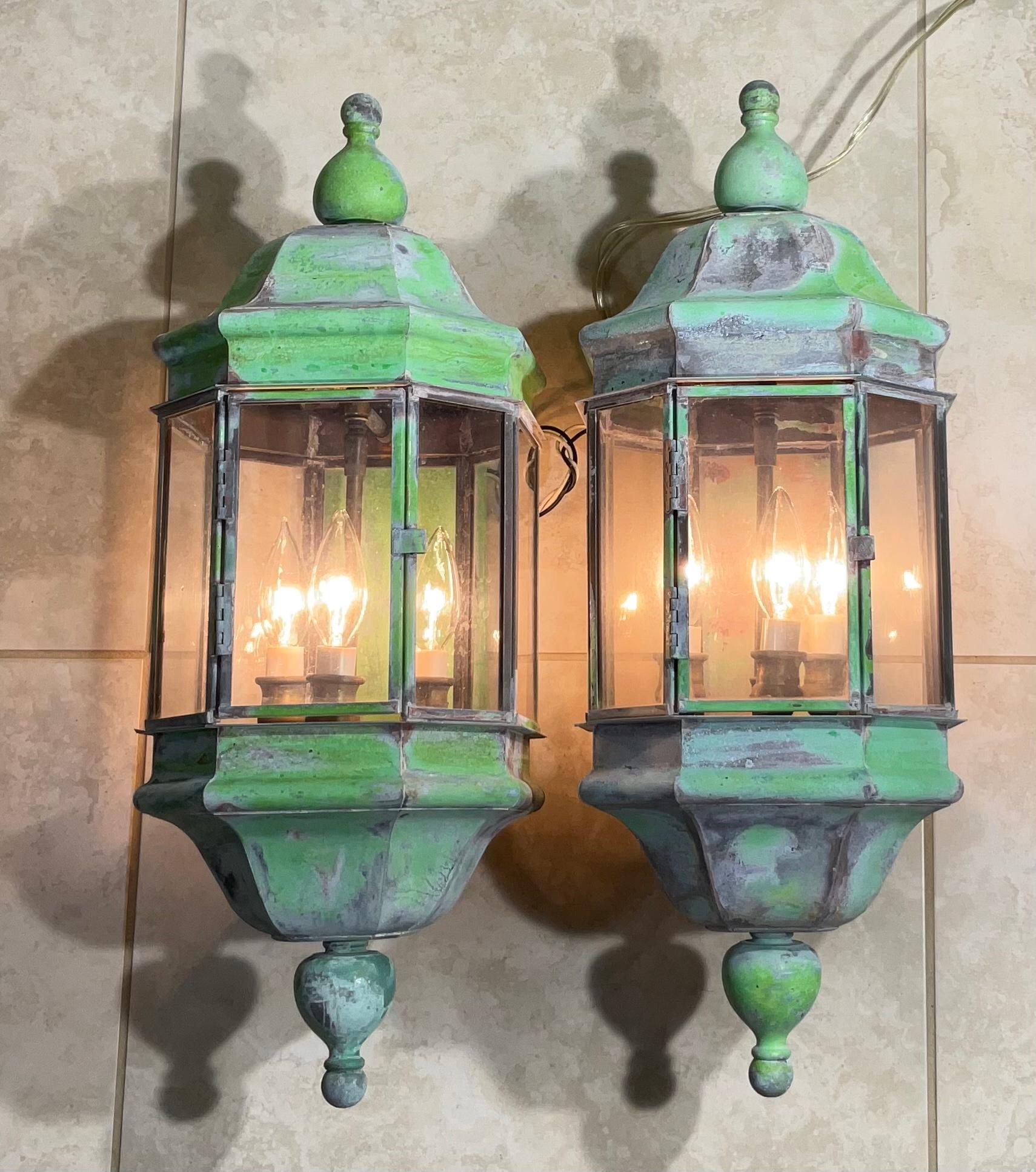 large pair of vintage wall lantern made of solid brass, quality workmanship, electrified with three 60/watt lights each, acrylic glass on all sides , great light exposure, beautiful patina.
Suitable for wet location. 
Decorative pair of lantern