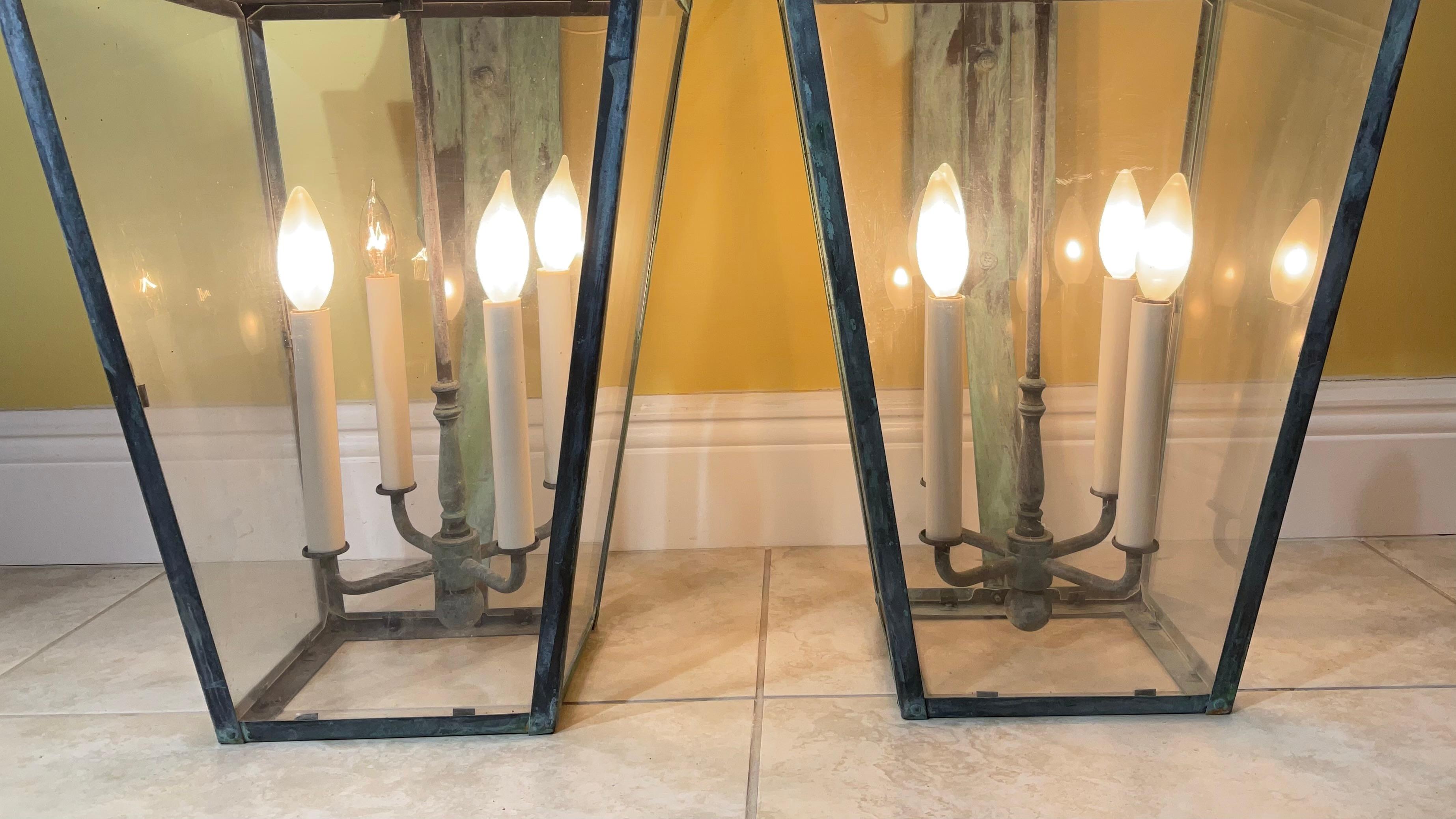 Exceptional large pair of vintage wall lantern made of solid brass, quality workmanship, electrified with four 40/watt lights each, beautiful patina ,Great light exposure, acrylic glass like on four sides.
Suitable for wet location. 
Backplate size