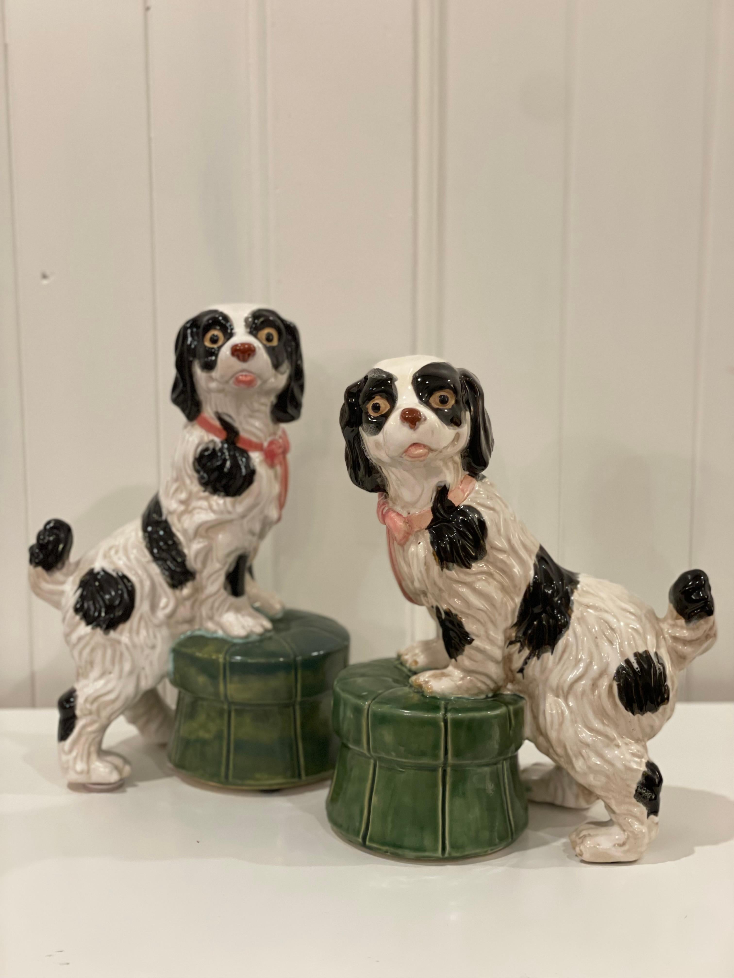 A very handsome pottery Cavalier King Charles Spaniel Dog Pair with paws up on a green tufted ottoman. They are made of durable pottery and have a beautiful iridescent glaze on top. 

Made in an English Staffordshire wally dog style, these handsome