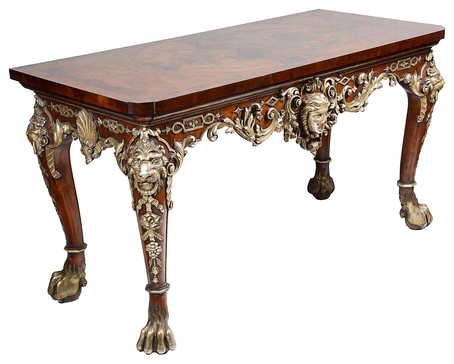 A very impressive pair of walnut and silver gilt William Kent style console tables, each having oyster walnut veneered tops, carved wood apron of scrolling foliate and motif decoration. Classical mask and lions head mounts, raised on powerful