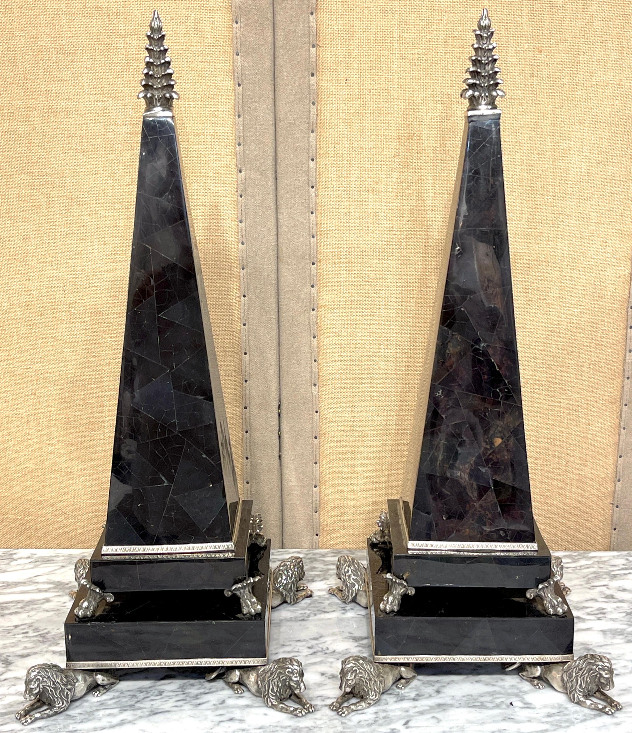 Large Pair Silverplated Bronze and Inlaid Coconut Shell Lion Motif Obelisks 
By Maitland-Smith, Later 20th Century 

A stunning large pair of Neoclassical obelisks by Maitland-Smith, made in the late 20th century. Each obelisk stands an impressive