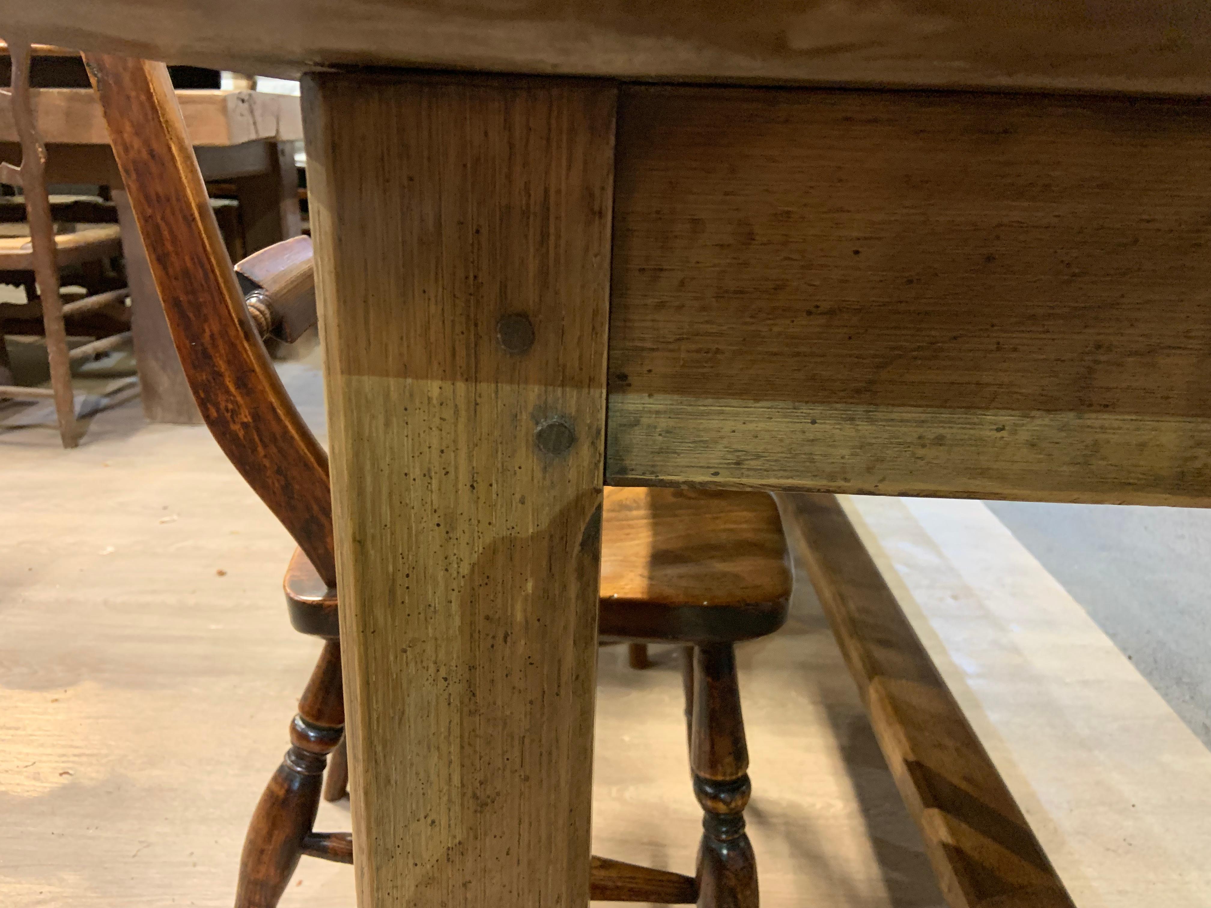 Antique Chestnut farmhouse table that sits on square legs with a centre stretcher and has one side drawer. The three plank top has lovely colour. Plenty of leg room at 24.5