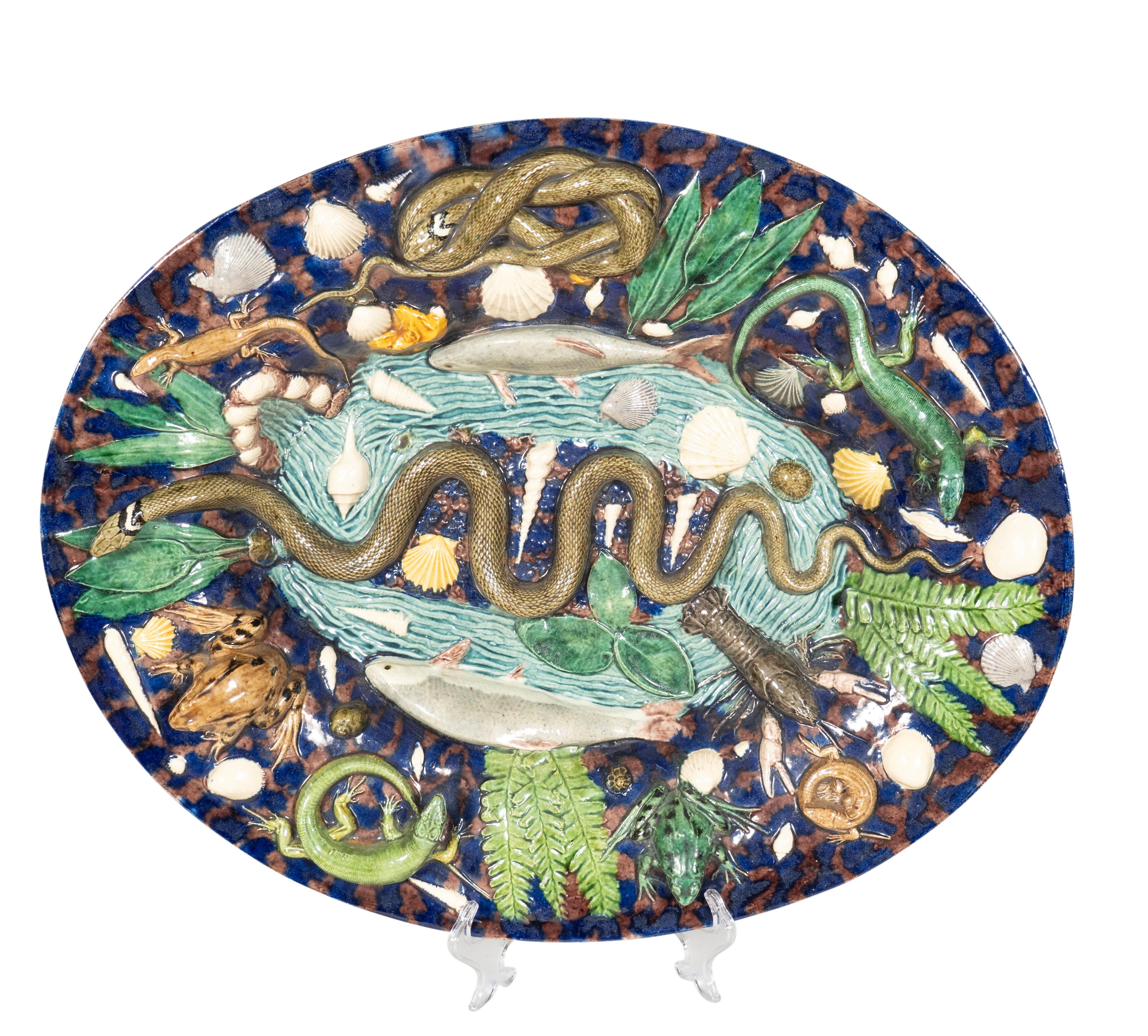 Large platter with central snake with fish and crayfish. The border with various reptiles and snakes, shells etc. Could not find signature. Probably by George Pull.
