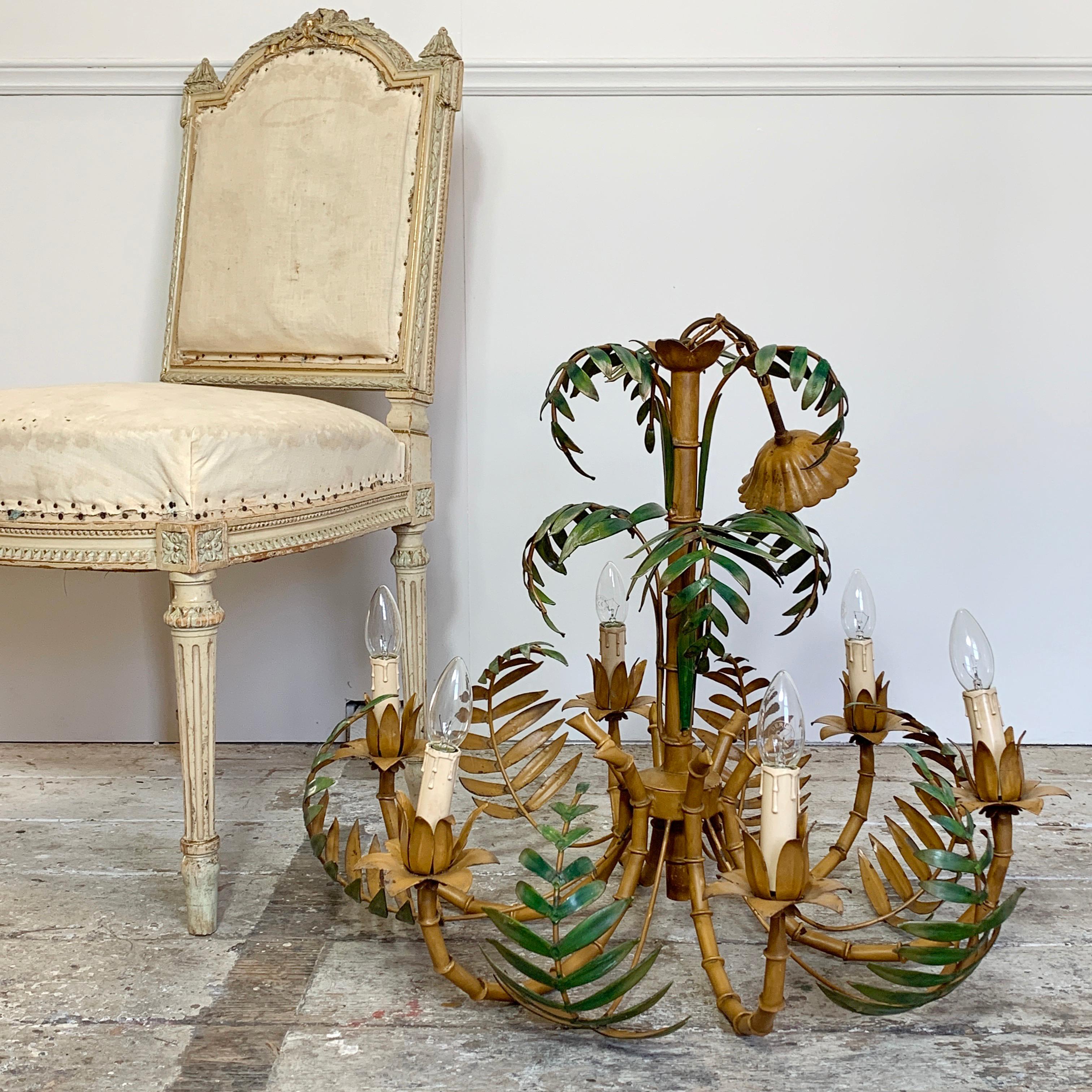 Very large palm leaf and faux bamboo tole chandelier, 1960s
A beautiful chandelier featuring faux bamboo stems with palm leaf fronds throughout
There are 6 bulb holders, E14 small screw in bulbs
Total drop 78cm, 56cm light height, 67cm width,