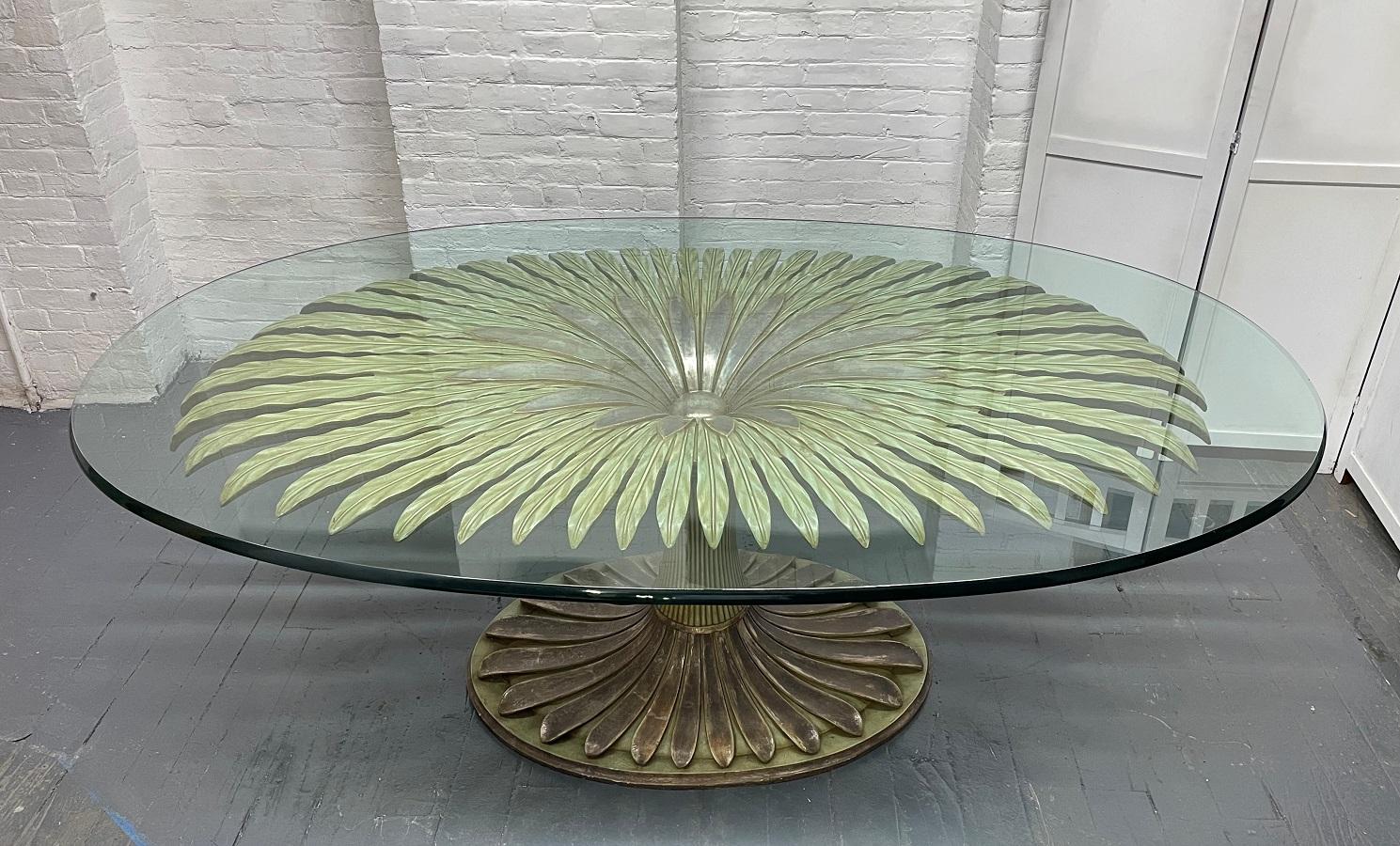 Large palm tree style oval glass top dining table or center table. The base is carved wood with a one inch thick glass. The base of the table is well made with palm tree style design.