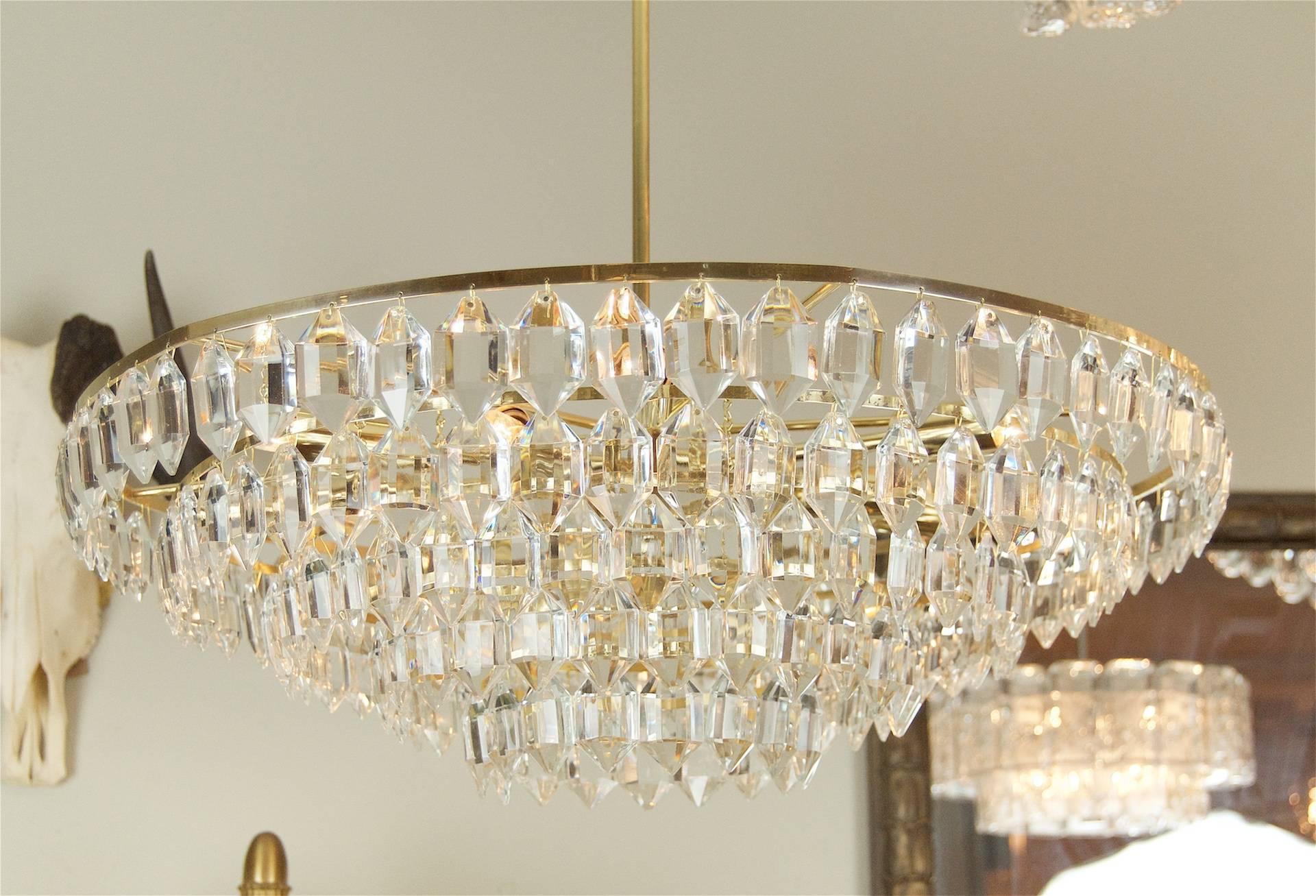 Large chandelier by Palwa consisting of five tiers of hexagonal crystals. Well-sized and lustrous.

Takes 9 E-14 base bulbs up to 40 watts per bulb, new wiring.

Measure: Height listed is of chandelier body only; height as hung is 23.5