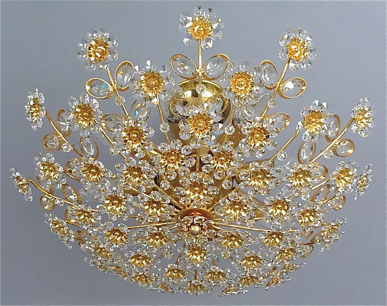 This is no. 1 of 3 available.
Large round gilt brass metal crystal glass floral flush mount chandelier made by Palwa, Germany, circa 1960-1970, documented in the Palwa sales catalog, labeled with Palwa company decal with model number. The gorgeous