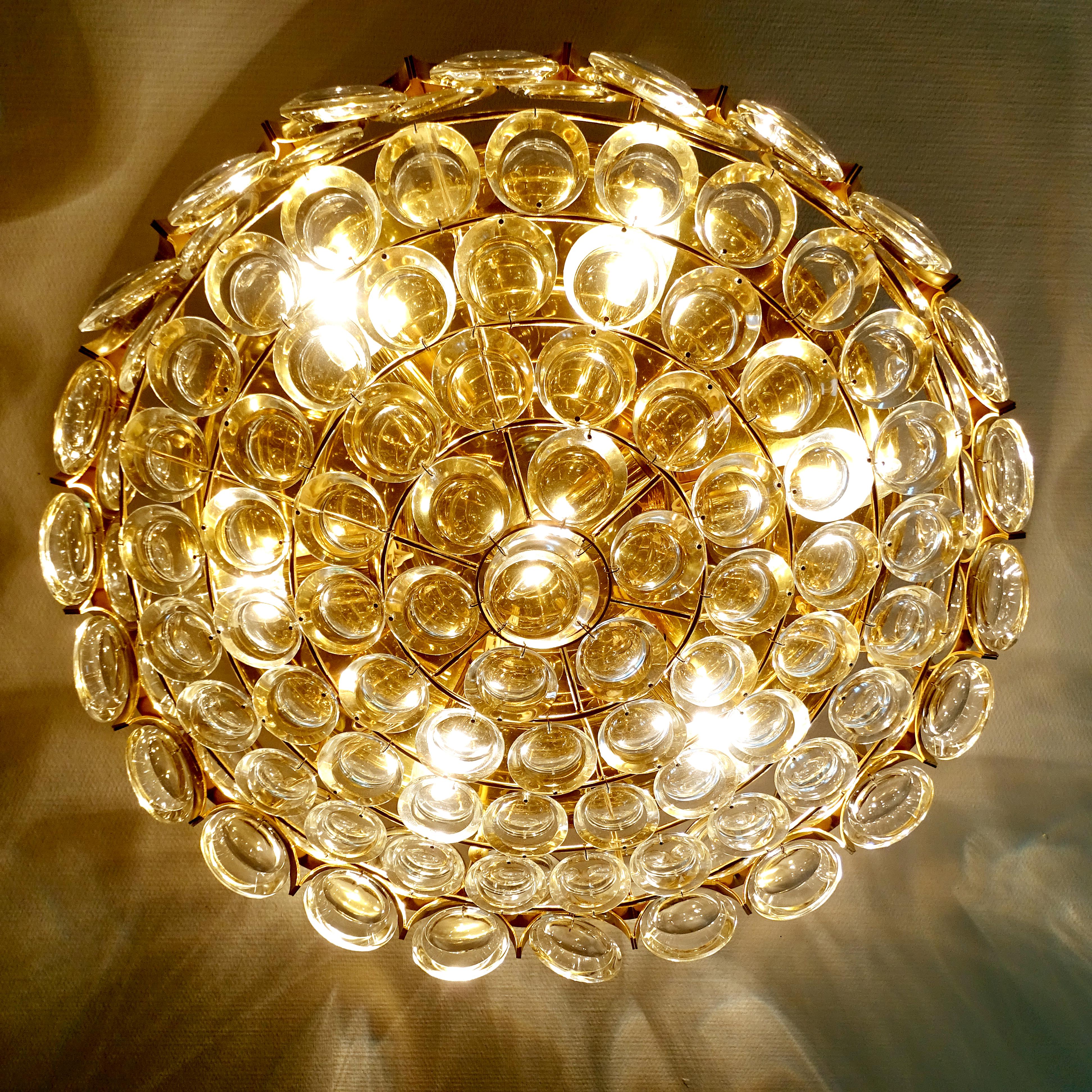 Mid-Century ceiling  fixture by Palwa. Palwa (which stands for Palme & Walter) is the oldest german lighting company  dating from the late 18th Century , The Light features a large brass circular base with 6 rows of crystal arranged in circular