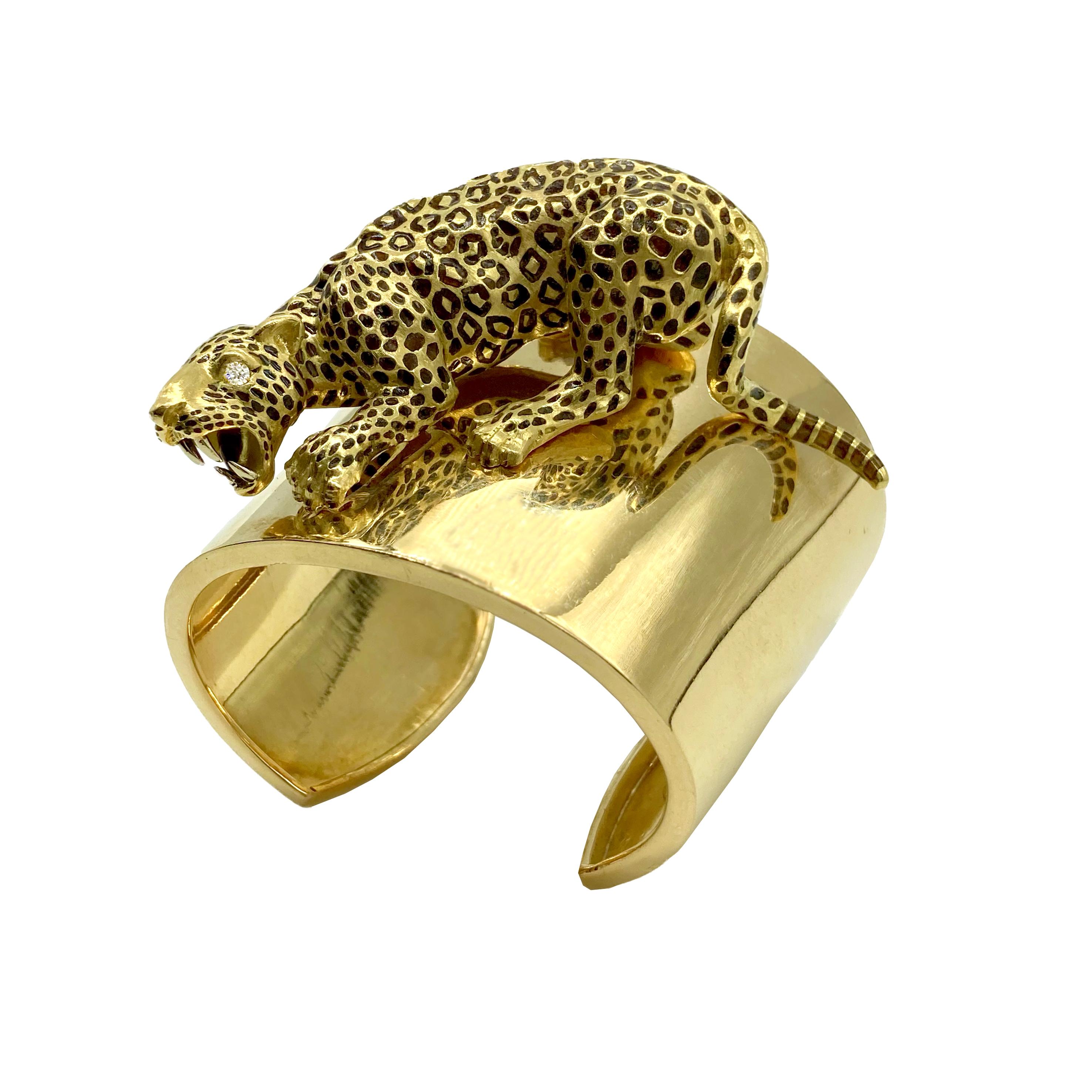 A chic yellow gold statement cuff bracelet featuring a large panther with diamond eyes. 