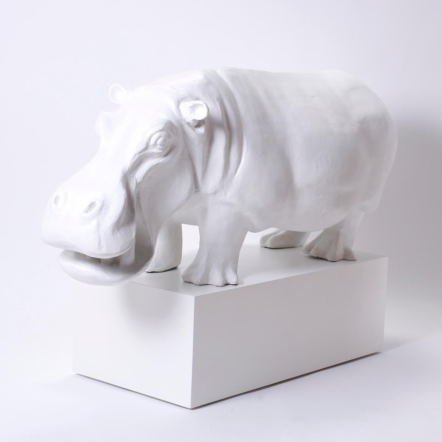 A very fun and decorative papier mâché hippopotamus by Sergio Bustamante, complete with custom pedestal. Very light and easy to handle, this hippo adds humor and taste to any room. White paint is a later addition. 

