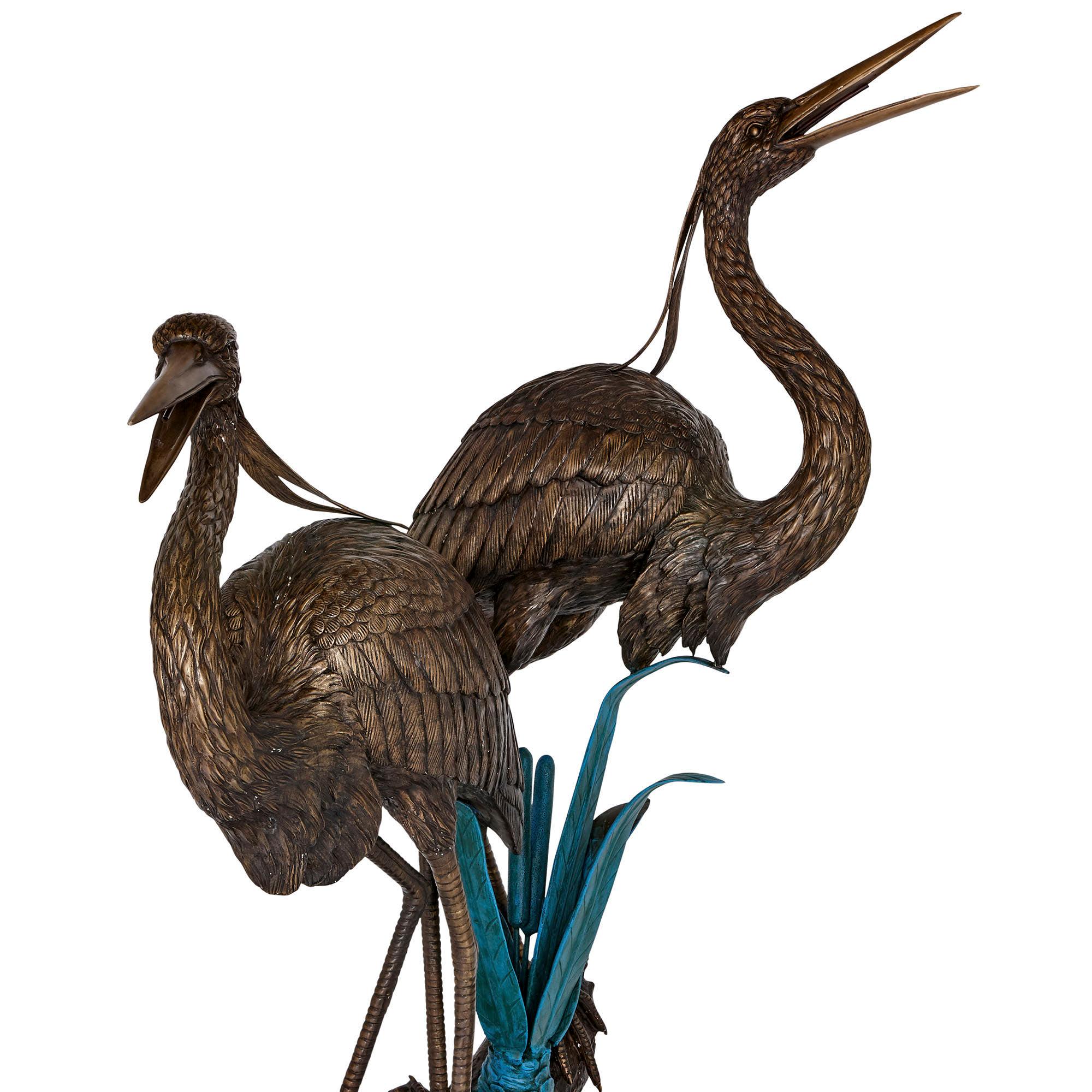 This wonderful patinated bronze work is designed to function as both a water fountain and a superb piece of sculpture. The item will be well-suited to either an indoor or outdoor setting.

The piece takes the form of two herons (birds), perched on