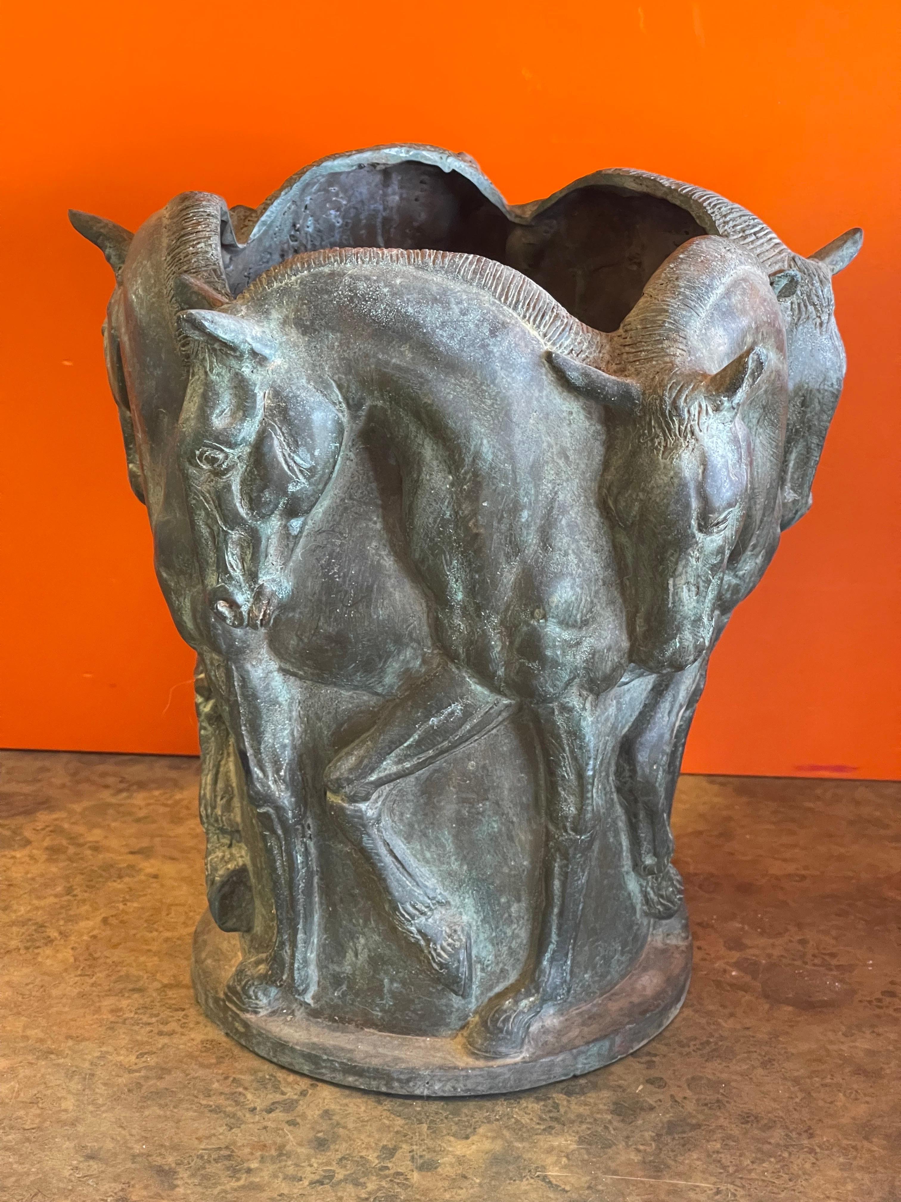 Wonderfully detailed large patinated bronze vase with horse motif, (five horses in profile encircling the vase) circa 1950s. The vase is in very good vintage condition and measures 9.5
