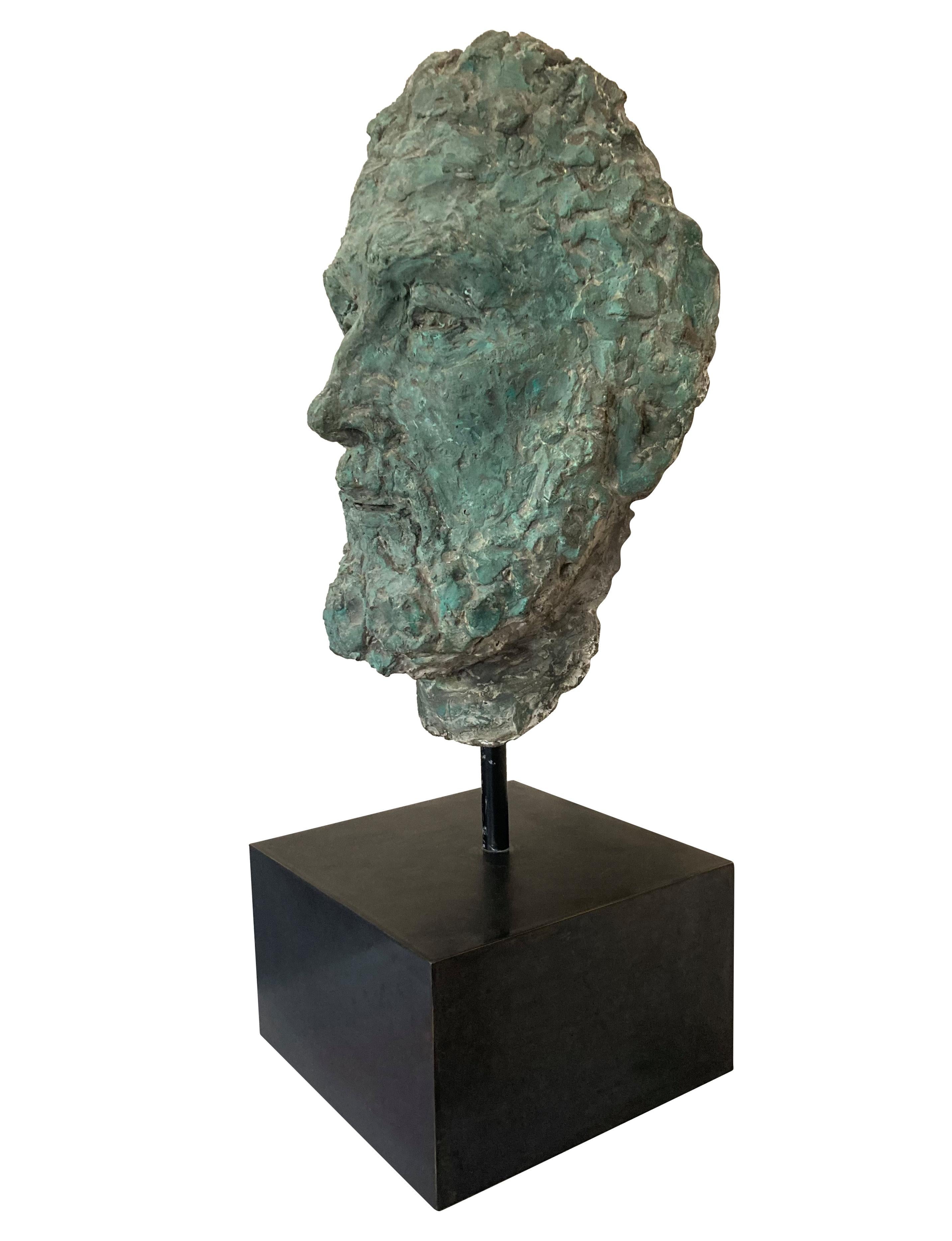 A large patinated (bronze powder) clay head of Zeus, on a bronzed metal base.