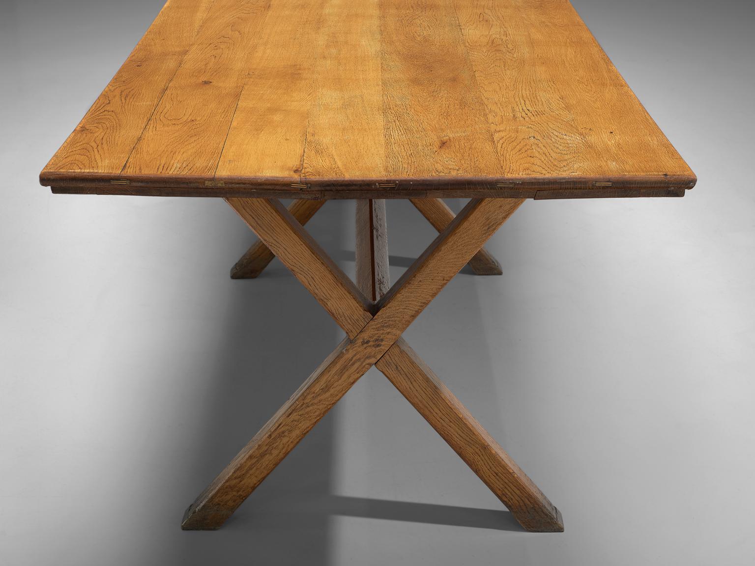 Dining table, solid oak, France, 1960s.

This large dining table is made of solid oak in the 1960s. The table features x-legs which gives the table an architectural appearance, which are slender. The table is robust, yet well-balanced. The table is