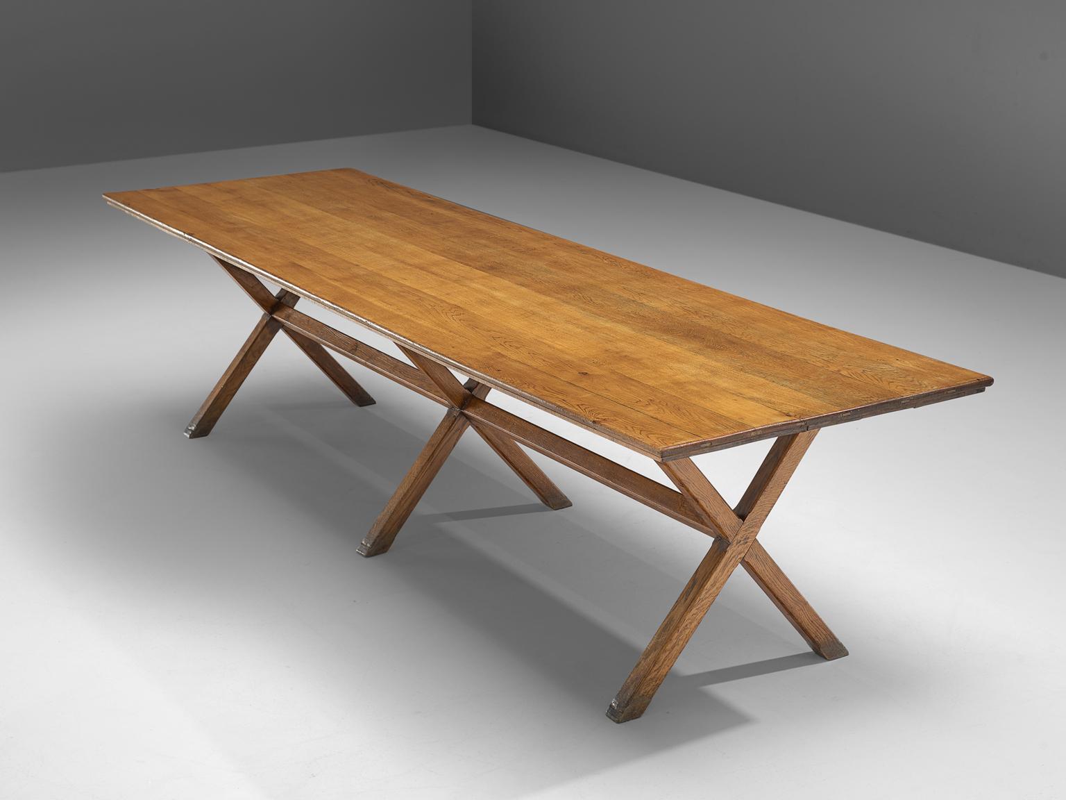 Dining table, solid oak, France, 1960s.

This large dining table is made of solid oak in the 1960s. The table features x-legs which gives the table an architectural appearance, which are slender. The table is robust, yet well-balanced. The table is