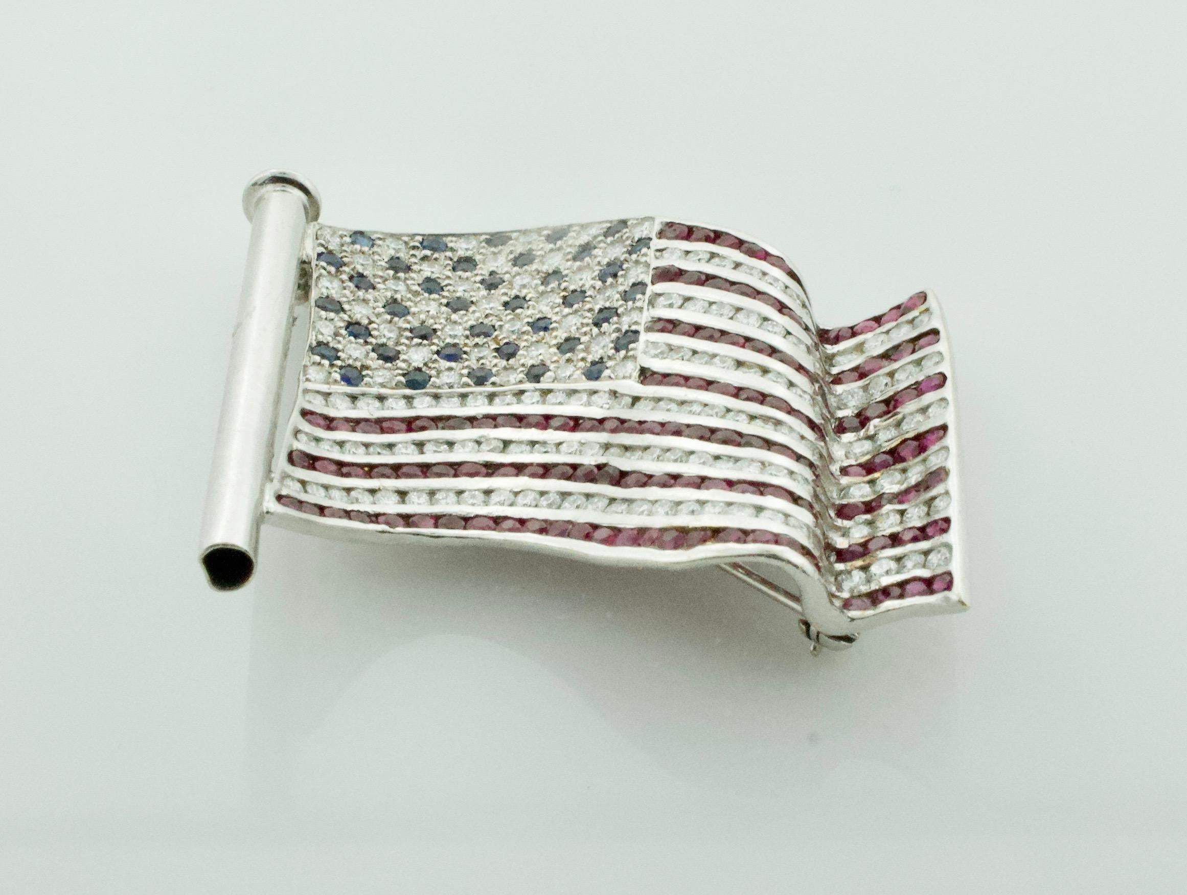 Large Patriotic United States Diamond, Ruby and Sapphire Flag Brooch in 18k 
One Hundred and Forty Five Round Brilliant Cut Diamonds Weighing 2.46 Carats [GH VVS-VS1]
Thirty Eight Round Sapphires Weighing .91 Carats Approximately [bright with no