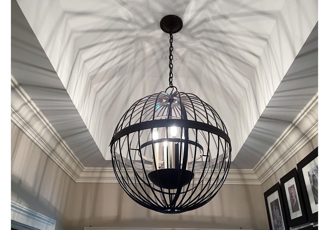 Large iron globe pendant with four candle lights within a second sphere and the bottom accentuated with a star motif. Beautifully crafted and fine Paul Ferrante quality. Bears Paul Ferrante labels.
Dimensions: 24