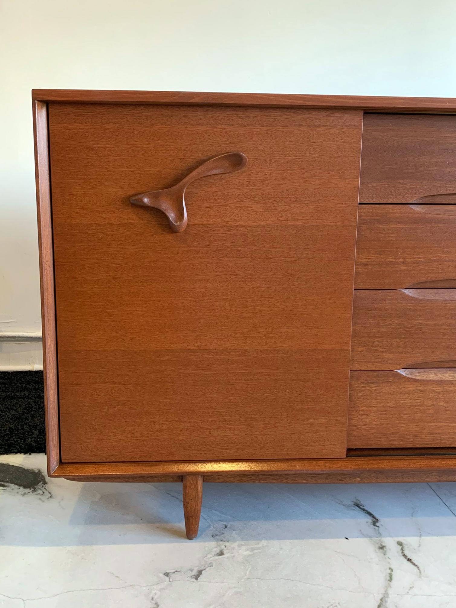This piece is truly striking! Immediately recognizable by its amoeba style sculpted wooden handles, this John Keal for Brown and Saltman is Mid-Century Modernism at its finest. John Keal Designed in the 1950s for Brown Saltman, this expertly