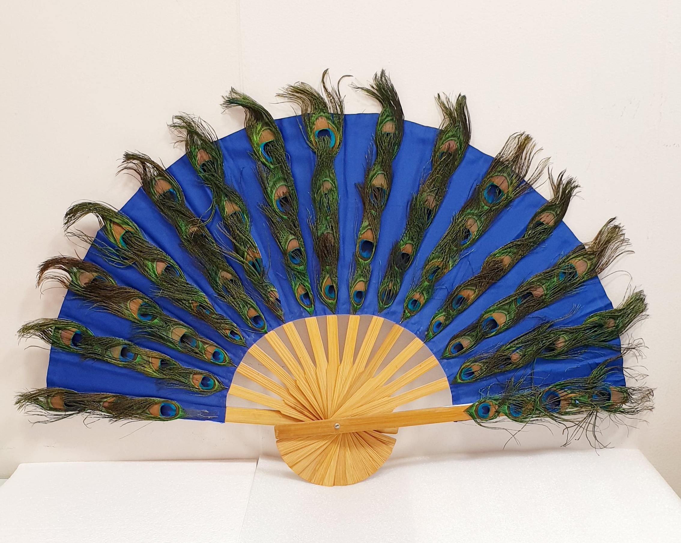 Large Peacok Feathers Fan in natural barnished pine wood   Open 75cm X 45cm / 29,52in x 17,71in
Ideal for cocktails and galas, for dancing and for breezing in hot weather.  In stock 6 
Perfect Condition.  Also for decoration or retail window shops.