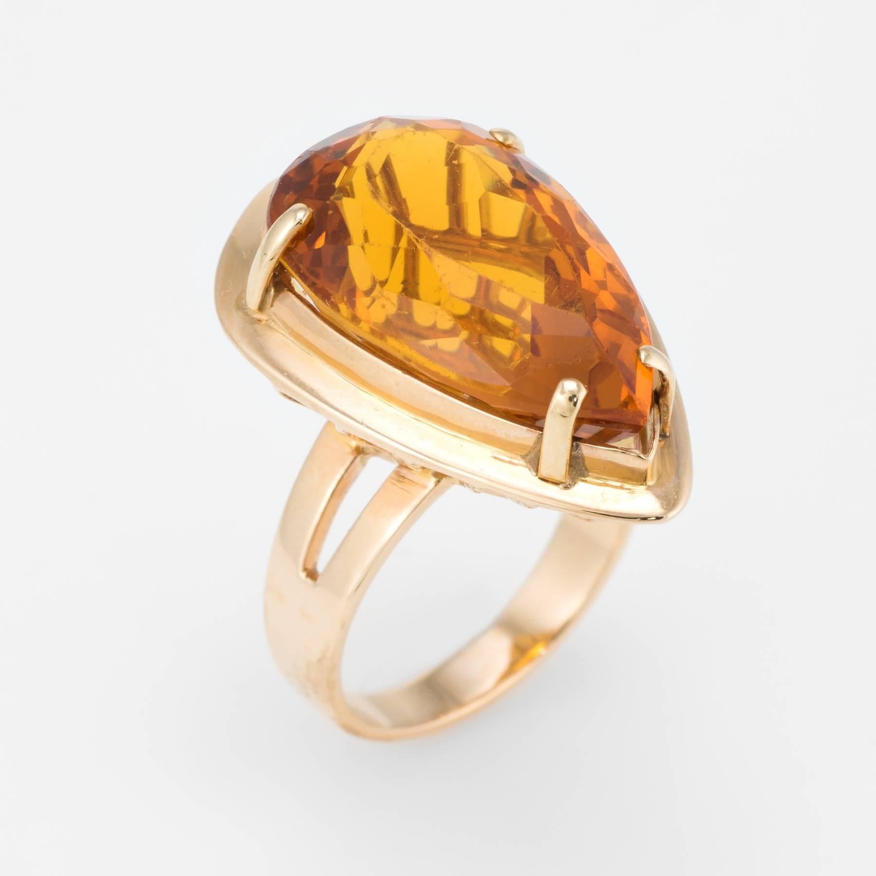 Elegant vintage cocktail ring (circa 1960s to 1970s), crafted in 14 karat yellow gold. 

Centrally mounted faceted pear cut citrine measures 24mm x 14mm (estimated at 20 carats). Note: few lights surface abrasions to the citrine.   

The ring is in