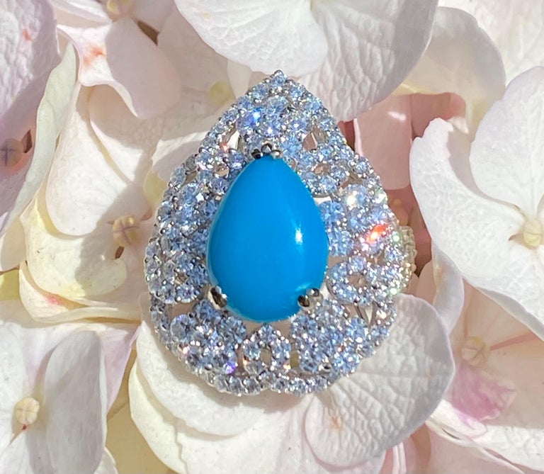 Stunning and totally dazzling, 18 karat white gold natural Persian turquoise and diamond cocktail ring features a 4.06 carat intense 