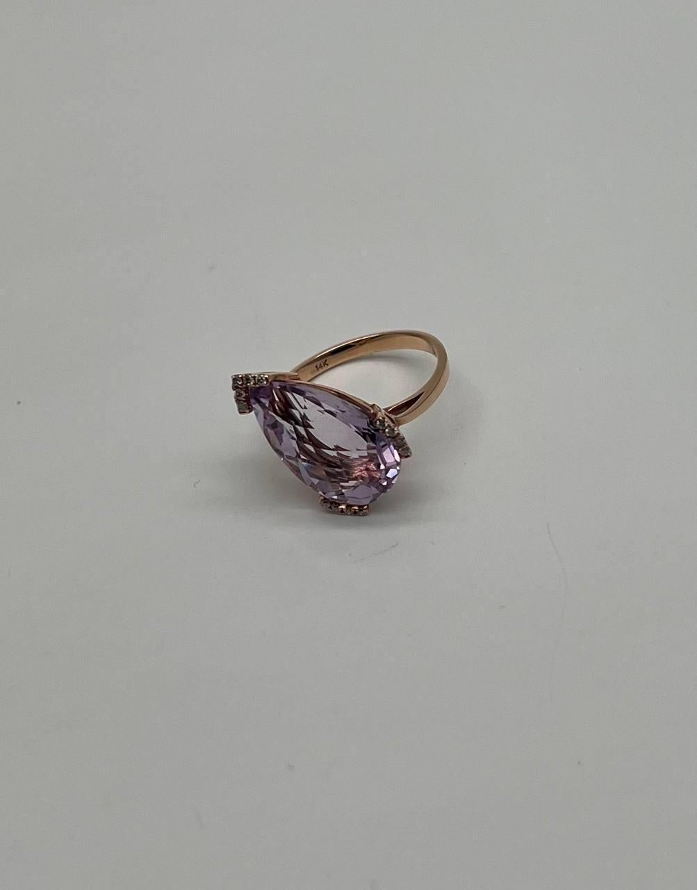 A sophisticated and elegant ring featuring a large pear-shaped amethyst of a delicate lavender hue. The ring is accented by accented, sparkling diamonds set around the gemstone, enhancing its brilliance. 14K Rose Gold. 0.10 CTW Diamonds. 8.74 cts