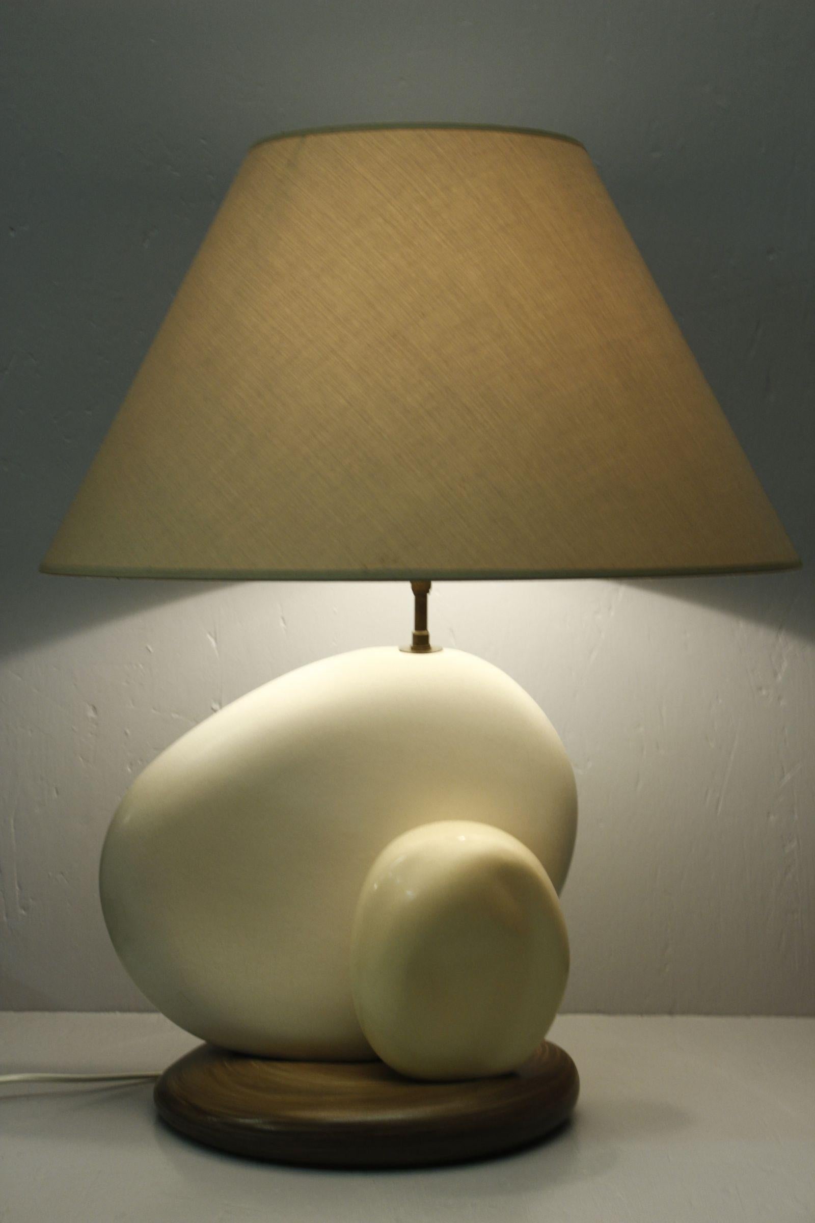 Large pebble ceramic lamp by French designer and lamp maker François Chatain, circa 1980. 

In soft white and brown enamel, with original shade that can be inclined thanks to a pivot below the bulb fitting, meaning one can adjust the intensity and