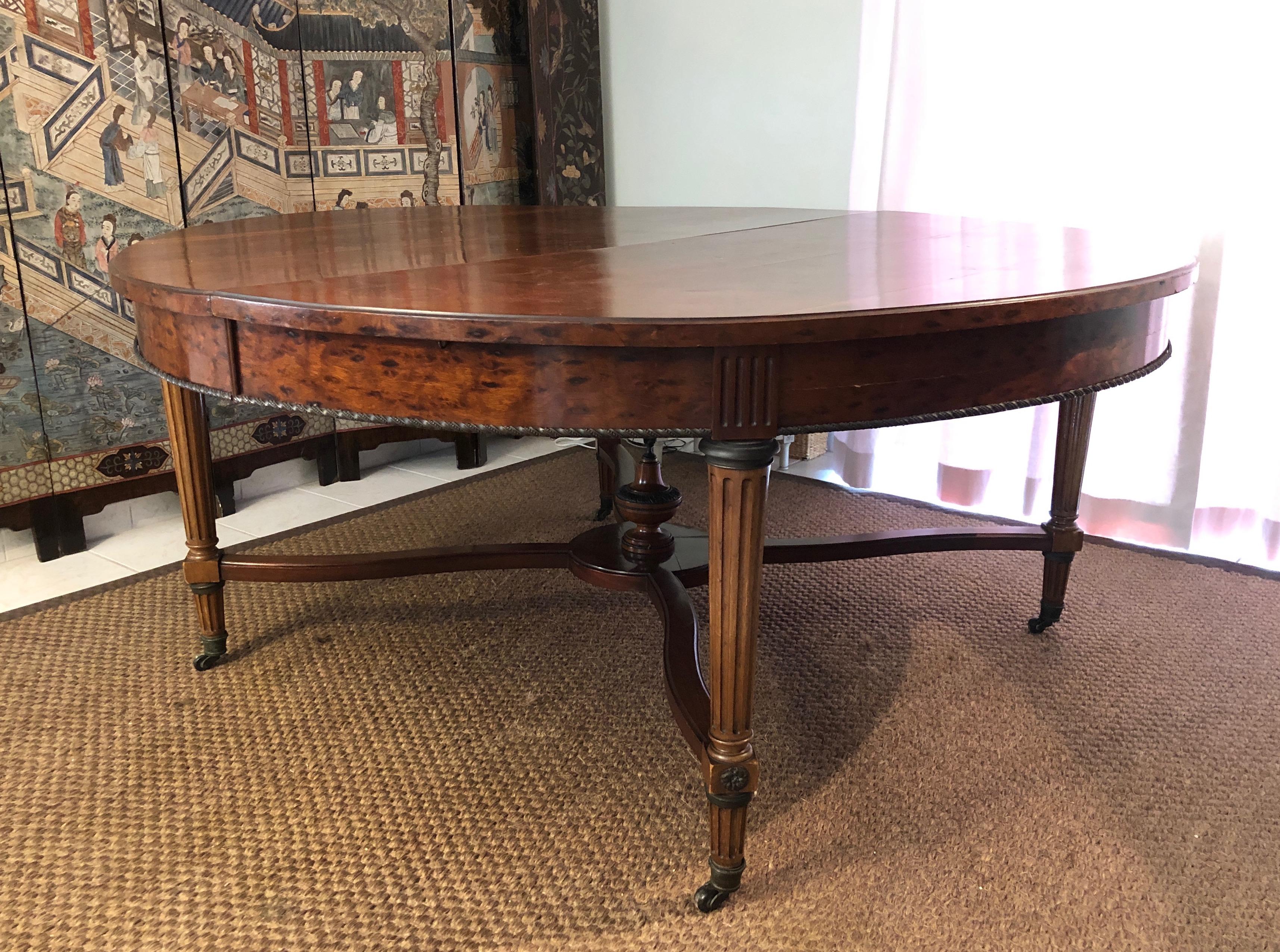 This very nice, decorative and rare large extensible pedestal table with central leg is made of wood, brass and bronze. It can be used as a large dining room table with 5 legs and extensions. This is a French work in the Louis XVI style. 19th