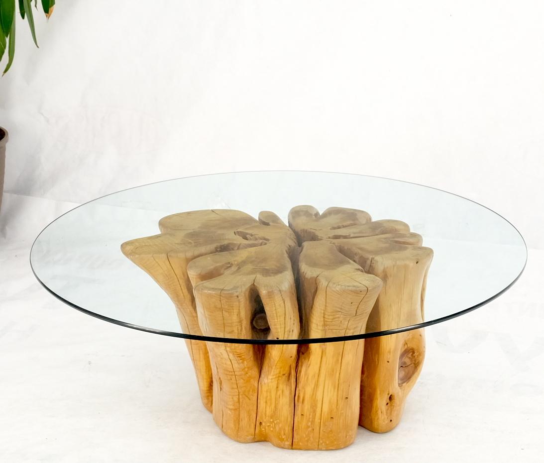 round glass table with tree trunk base