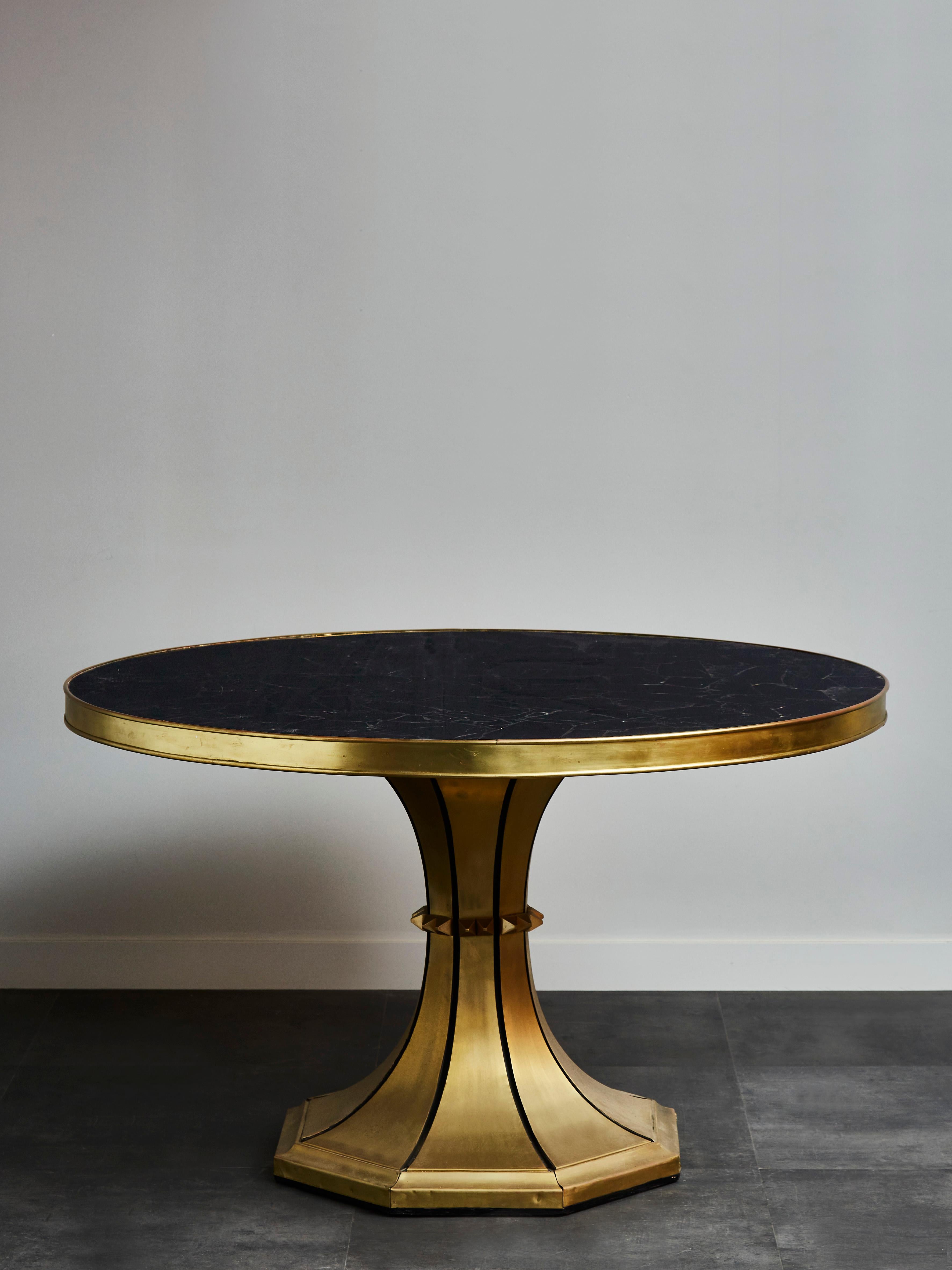 Large pedestal with vintage brass foot and obsidian top.