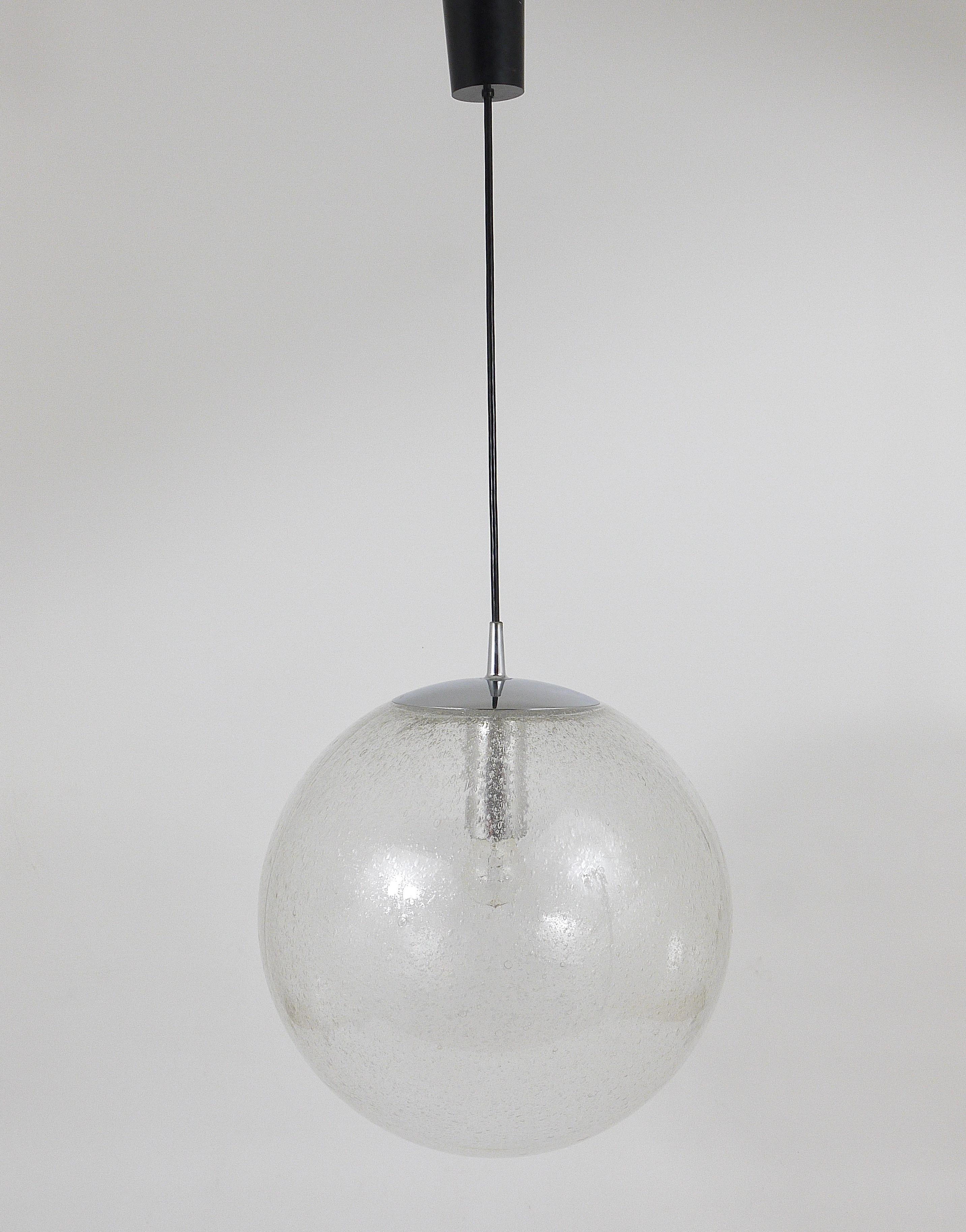 A beautiful Space Age pendant light with an extra large glass globe and chrome-plated hardware. The globe is made of hand blown bubble glass and has a diameter of 16 in. Executed in the 1970s by Peill and Putzler, Germany. In very good condition,
