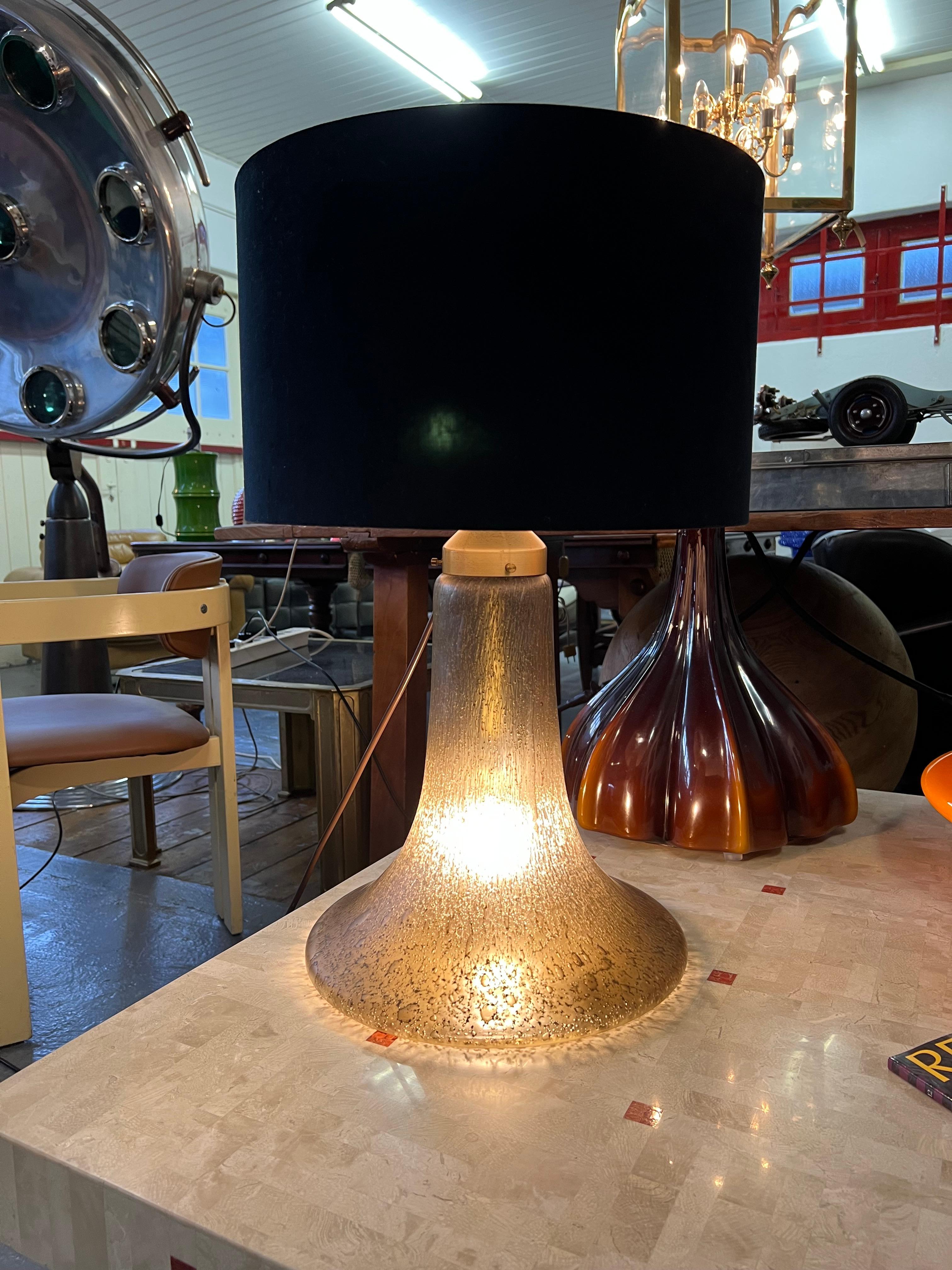 Large Peill & Putzler 1970s Murano Lava glass table lamp.
The item is in excellent condition.
The small air bubbles in the glass create a warm glow of light in your room.
The fact that the base illuminated gives a beatiful warm light.
Will be
