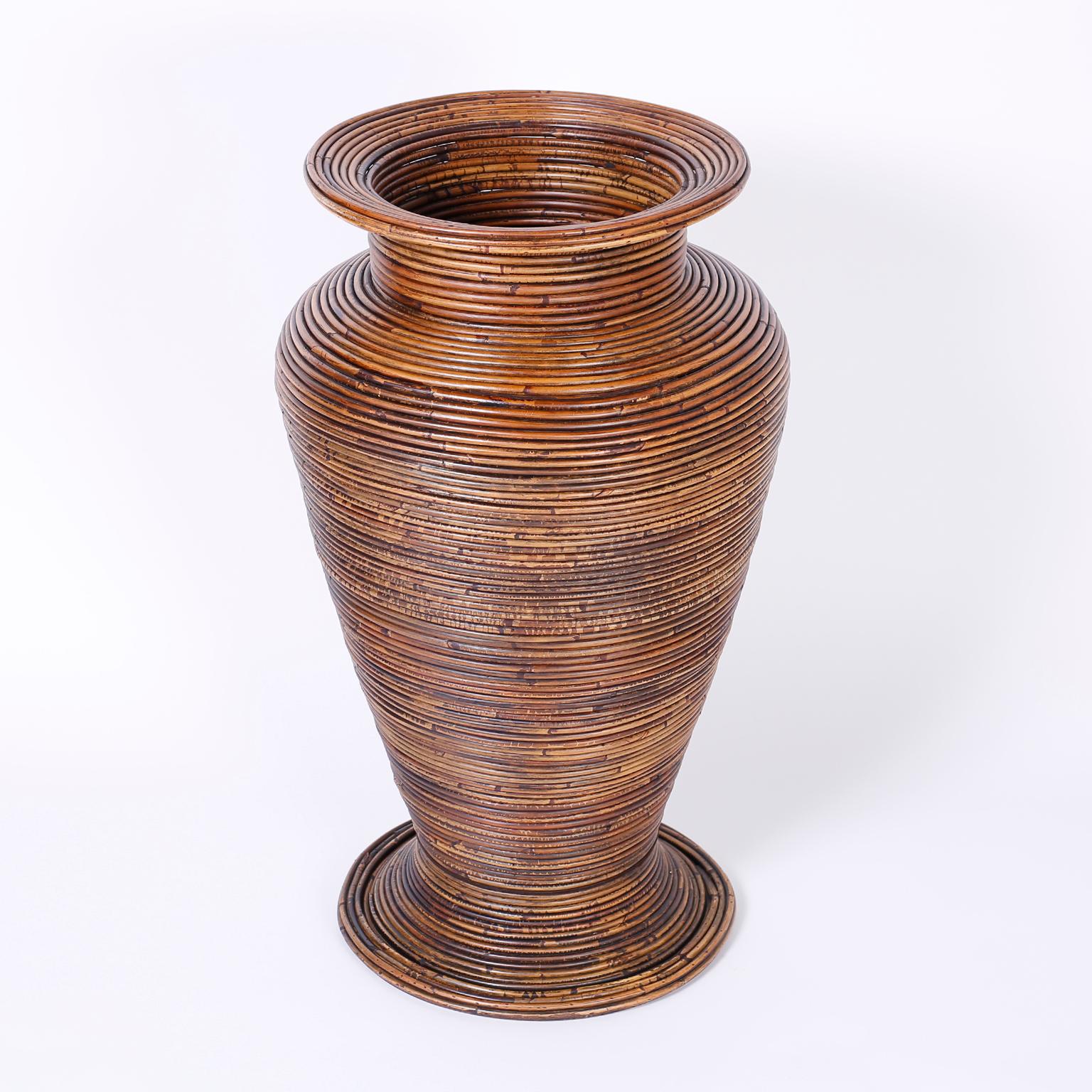 Midcentury floor vase crafted in pencil reed with a Classic form and warm lush finish.