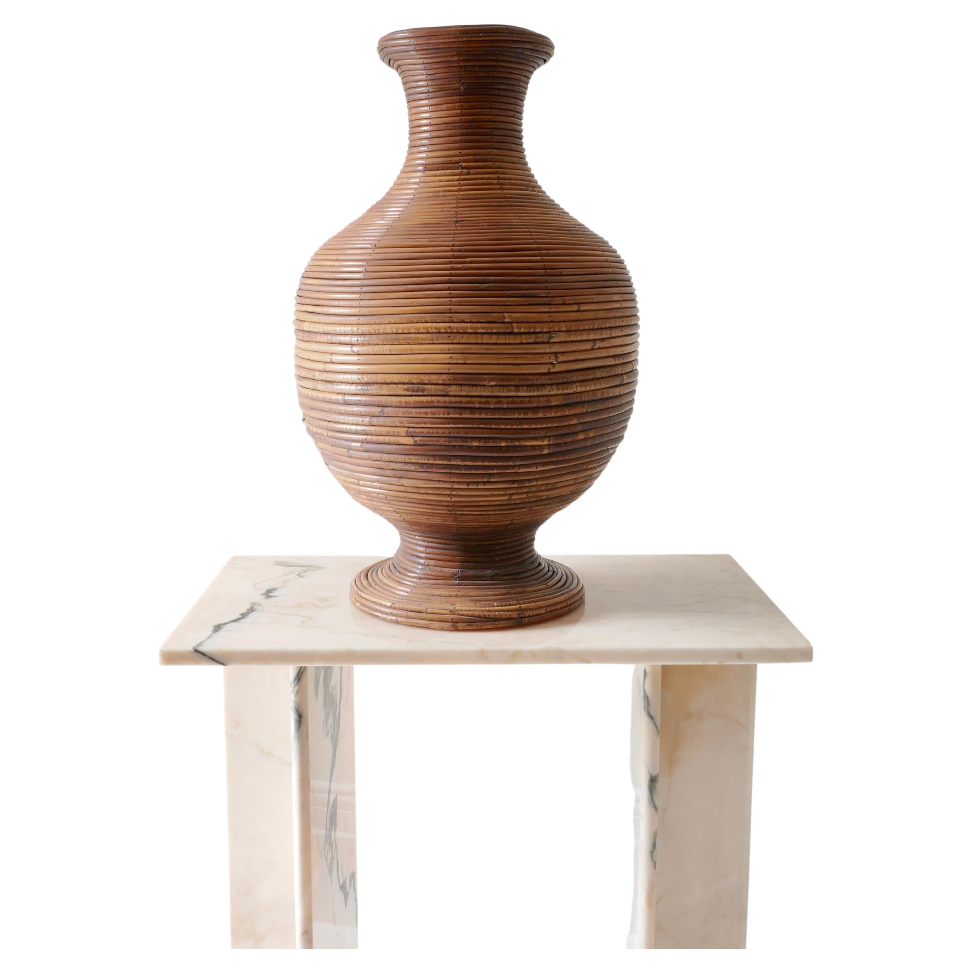 A substantial vase is perfect for holding dried arrangements or simply standing on its own. 
Large and impressive mid-century urn crafted in pencil reed in a classic round form with a lush warm finish. Timeless and eternally chic .

Base diameter