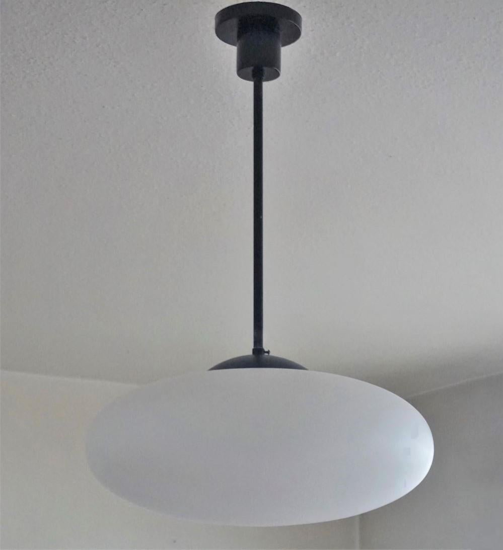 Pendant by Arredoluce manufactured in Italy, 1950s. With large brushed satin glass diffuser, black painted steel mounts. It takes one E27 100watt bulb. Rewired and ready to hang.
Measures: Diameter 20