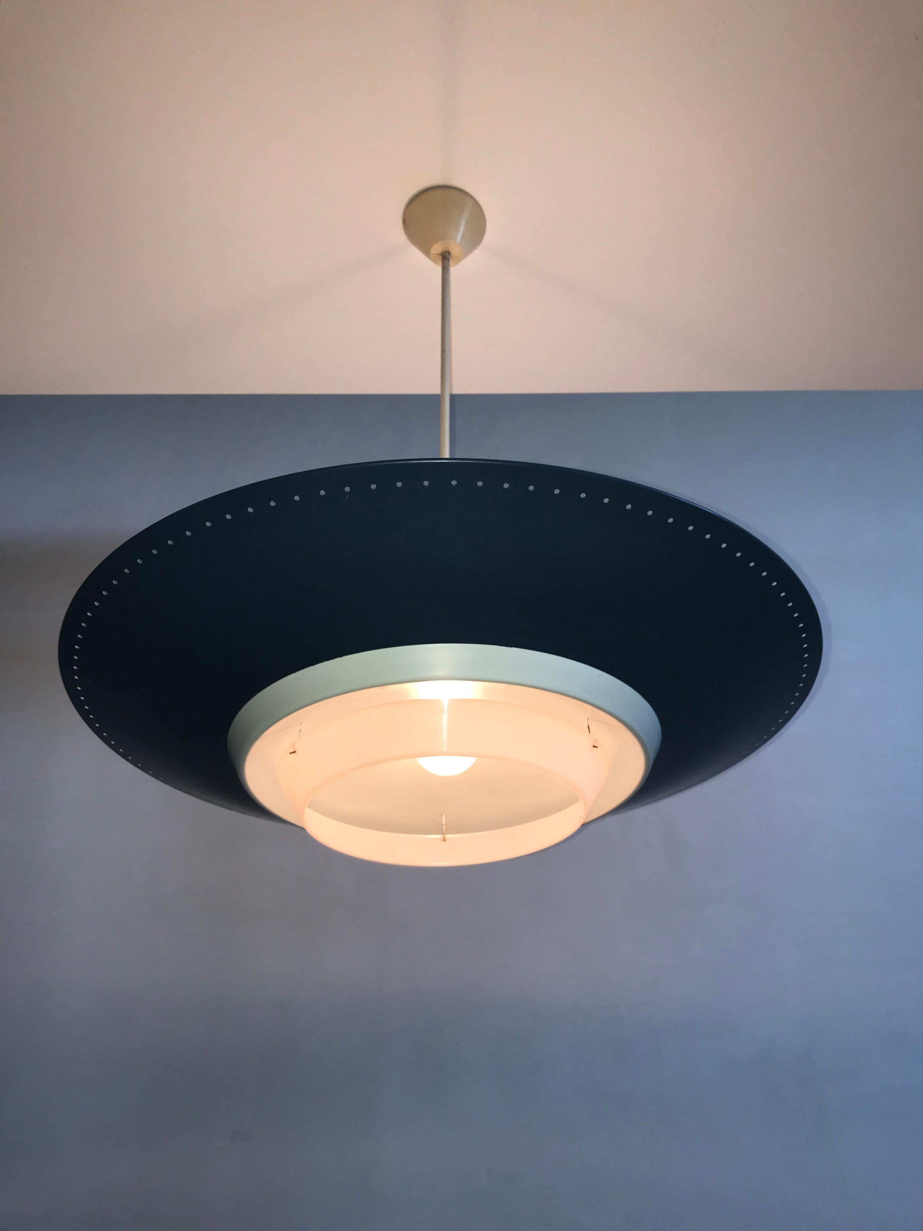 Large grey blue pendant by Louis Kalff for Phillips with label.
This Dutch design industrial lamp holds three lightbulbs at the top for upward light and one shining down.
 