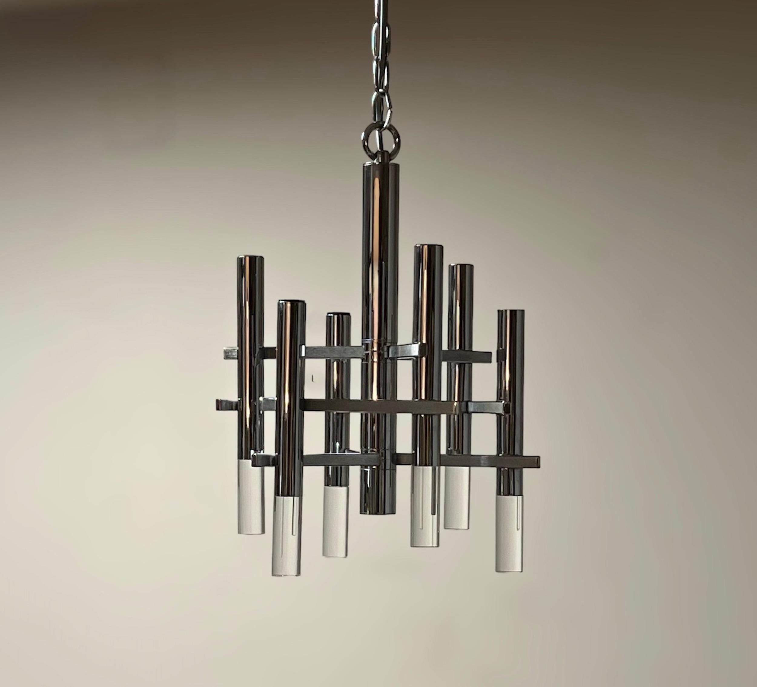 Iconic hanging lamp designed and produced by Gaetano Sciolari in the 1970s, made of metal tubes with perspex details.

Crafted with meticulous attention to detail, this iconic lighting fixture showcases a sleek, geometric metal frame that exudes a