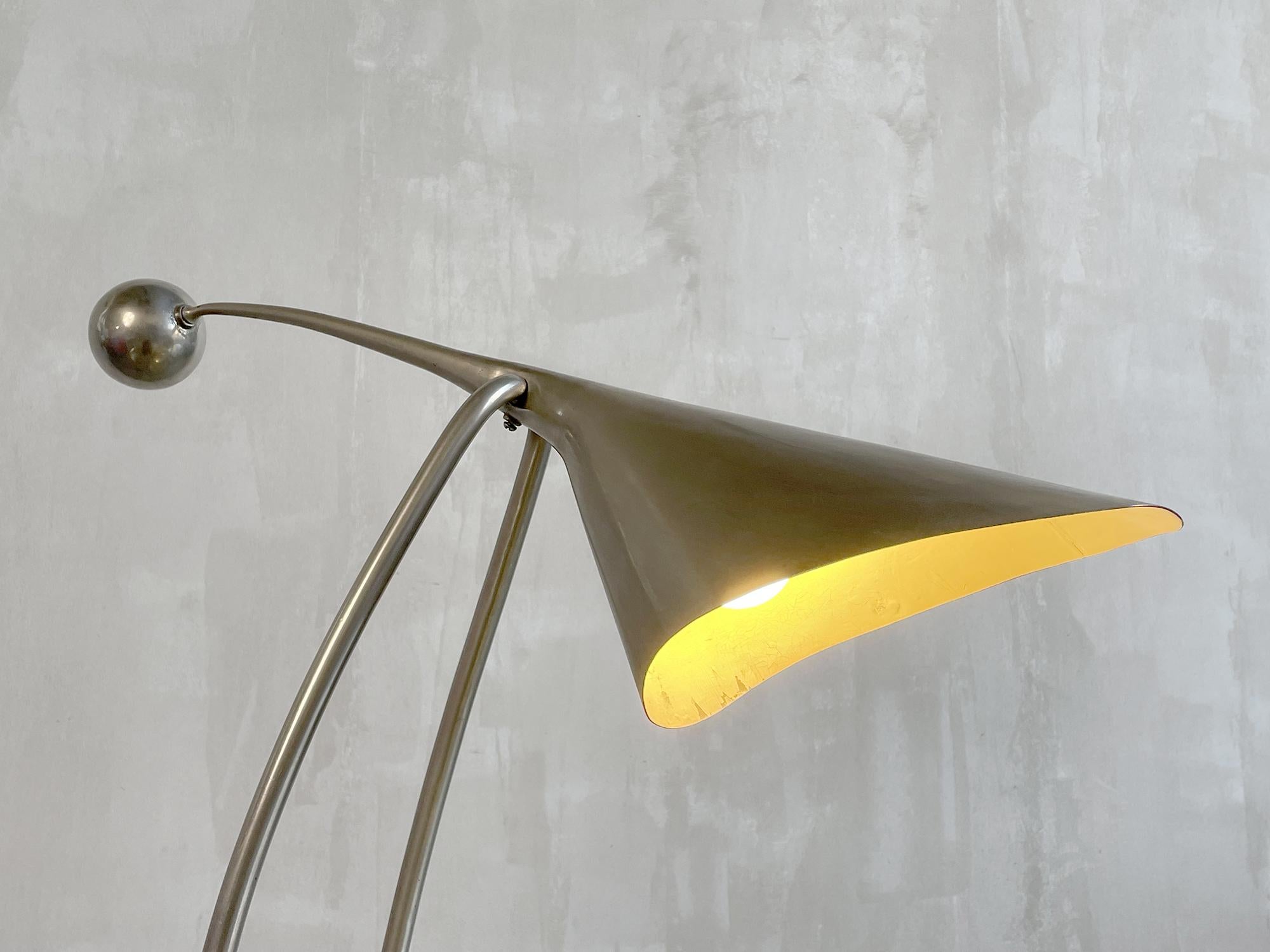 Spectacular pendulum lamp in polished metal, France 1960. The reflector in the shape of a witch's hat is counterbalanced by a counterweight, the rocking movement is slowed down by a screw. The tubular base is joined by a sphere fitted with a
