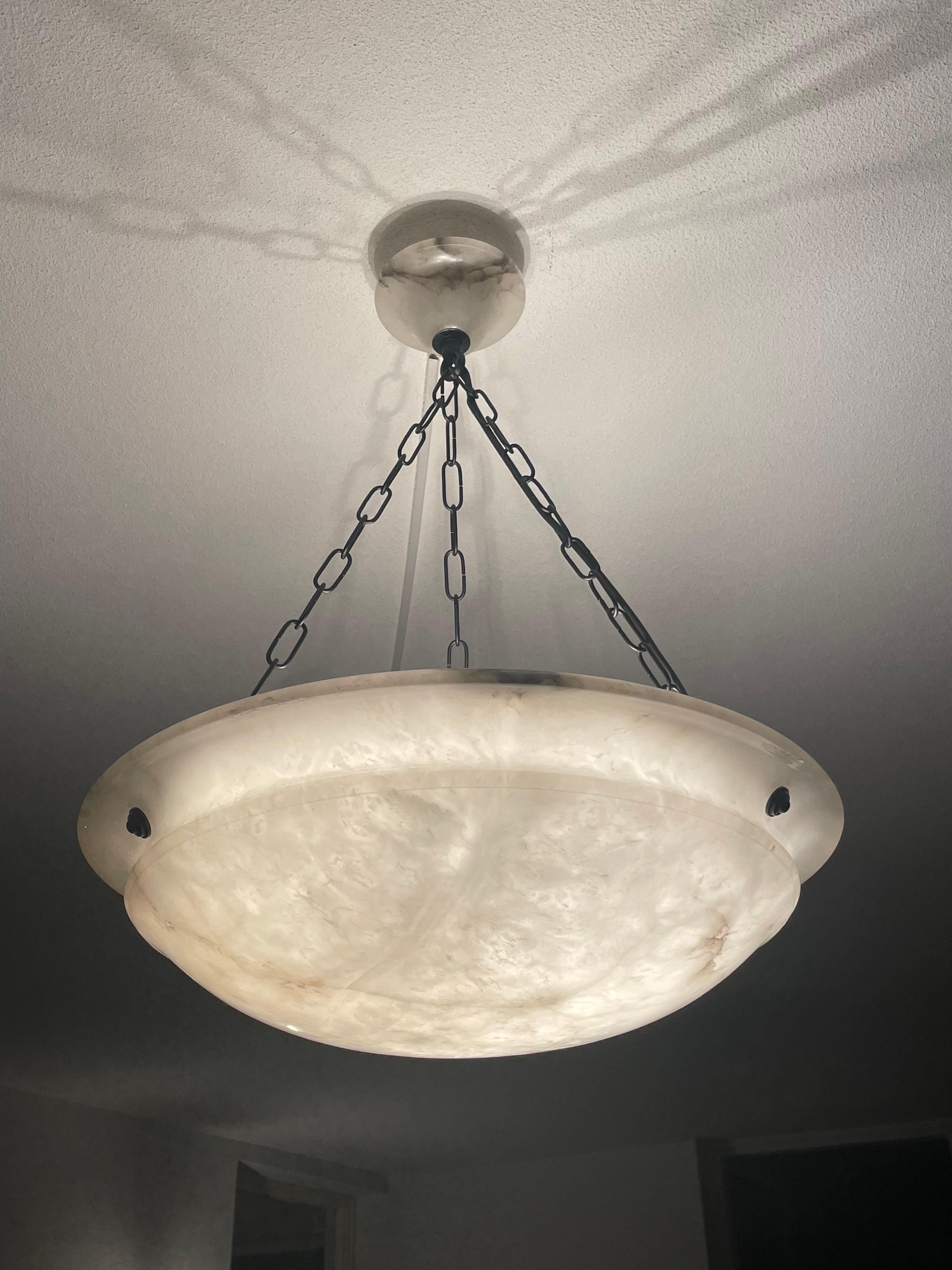 Beautiful and the ideal size 17.8 inches in diameter alabaster light fixture.

Thanks to its large size and timeless design this three light alabaster chandelier from the European Art Deco era is one of the most beautiful models we have seen and
