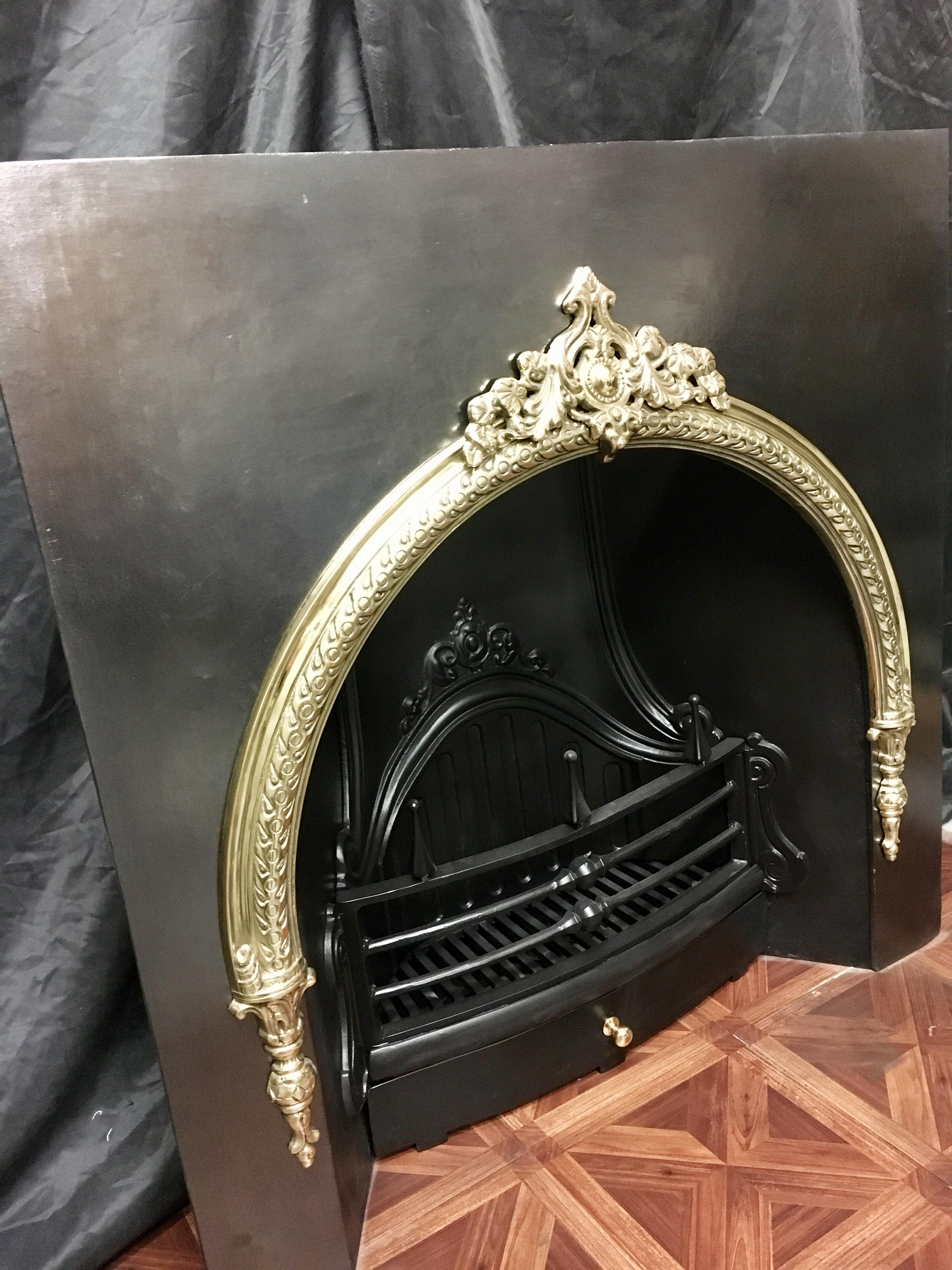 A large period cast iron and brass arched fireplace insert of superb quality,  in the Victorian manor fully restored and polished to its former glory. This is a large and heavy piece that will suit a variety of fireplaces.