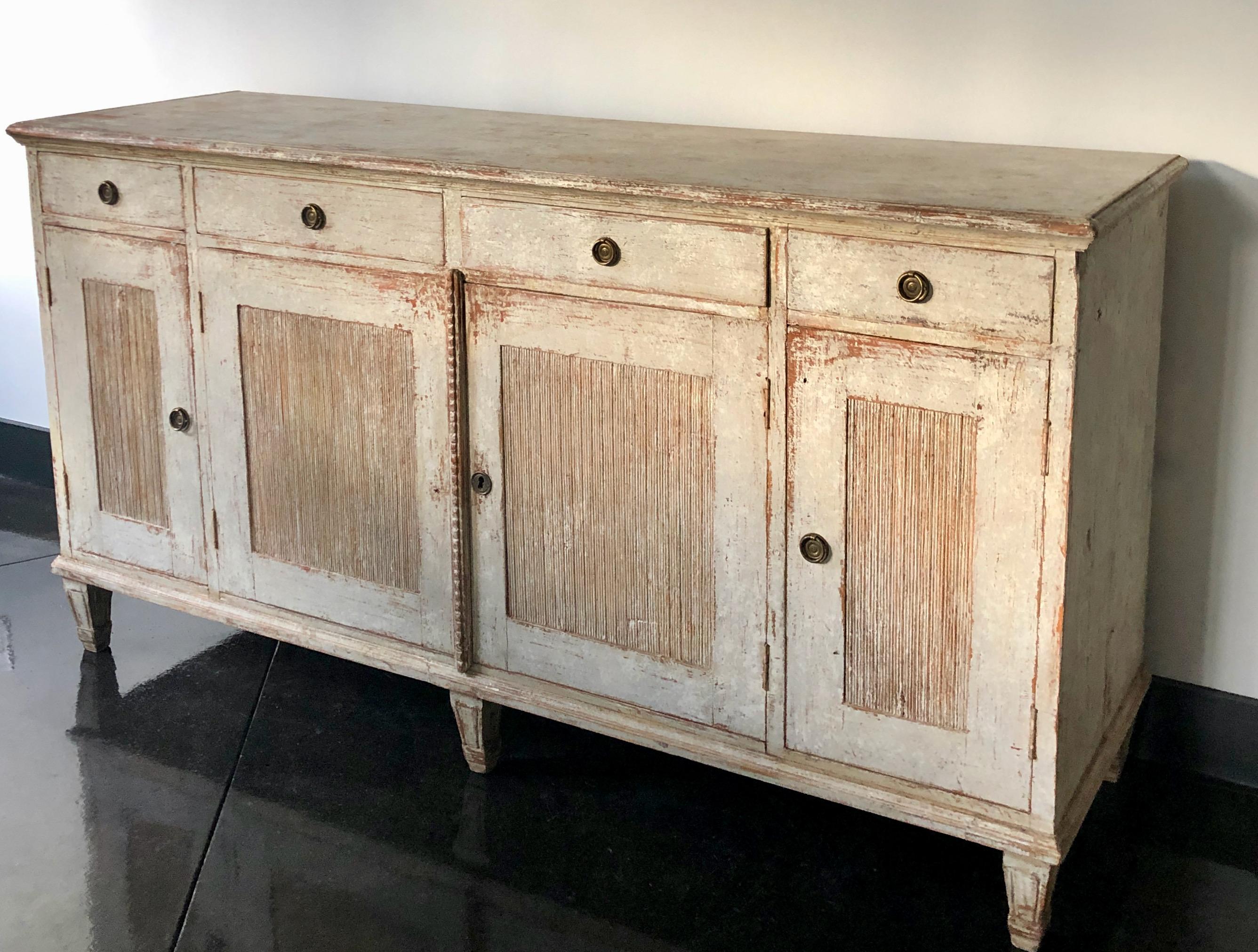 A rare four door Swedish sideboard in the classic Gustavian Style with carved reeded panel doors and bank of four drawers.
Upsala, Sweden, circa 1810.
  