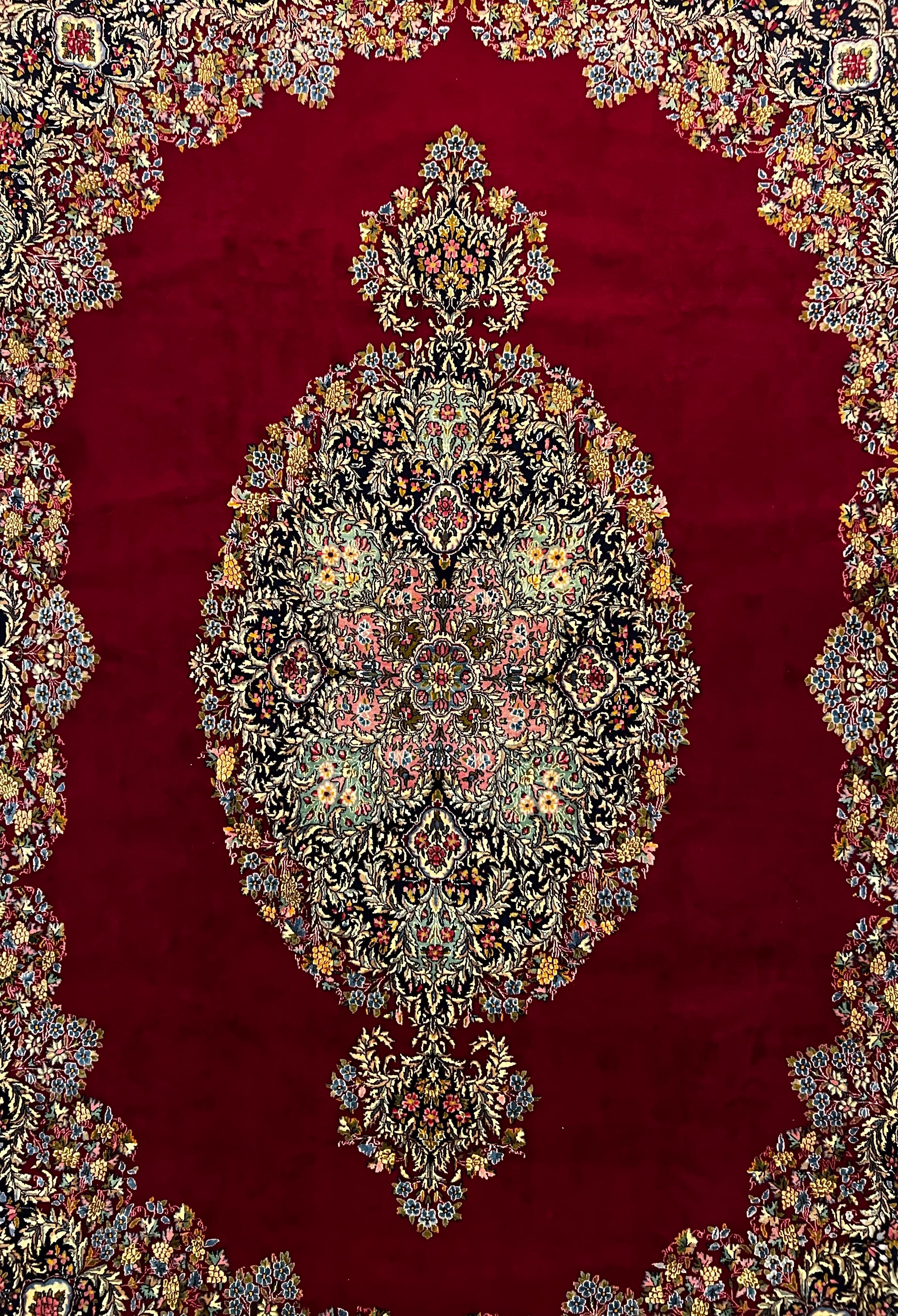  A luxurious and large  Kerman Lavar rug—a masterpiece meticulously hand-knotted with the finest blend of wool and cotton. Made in 1950's,  the high-pile craftsmanship lends a sumptuous feel, while the vibrant red color palette captures attention