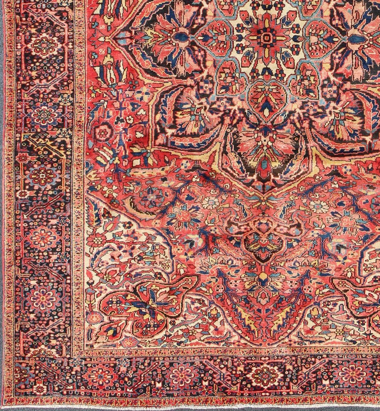 Soft reds and multi-color midcentury Persian Heriz rug with stylized medallion design, rug rm-m17420, country of origin / type: Iran / Heriz, circa 1950.

This magnificent antique Persian Heriz carpet from the mid-20th century (circa 1950) bears