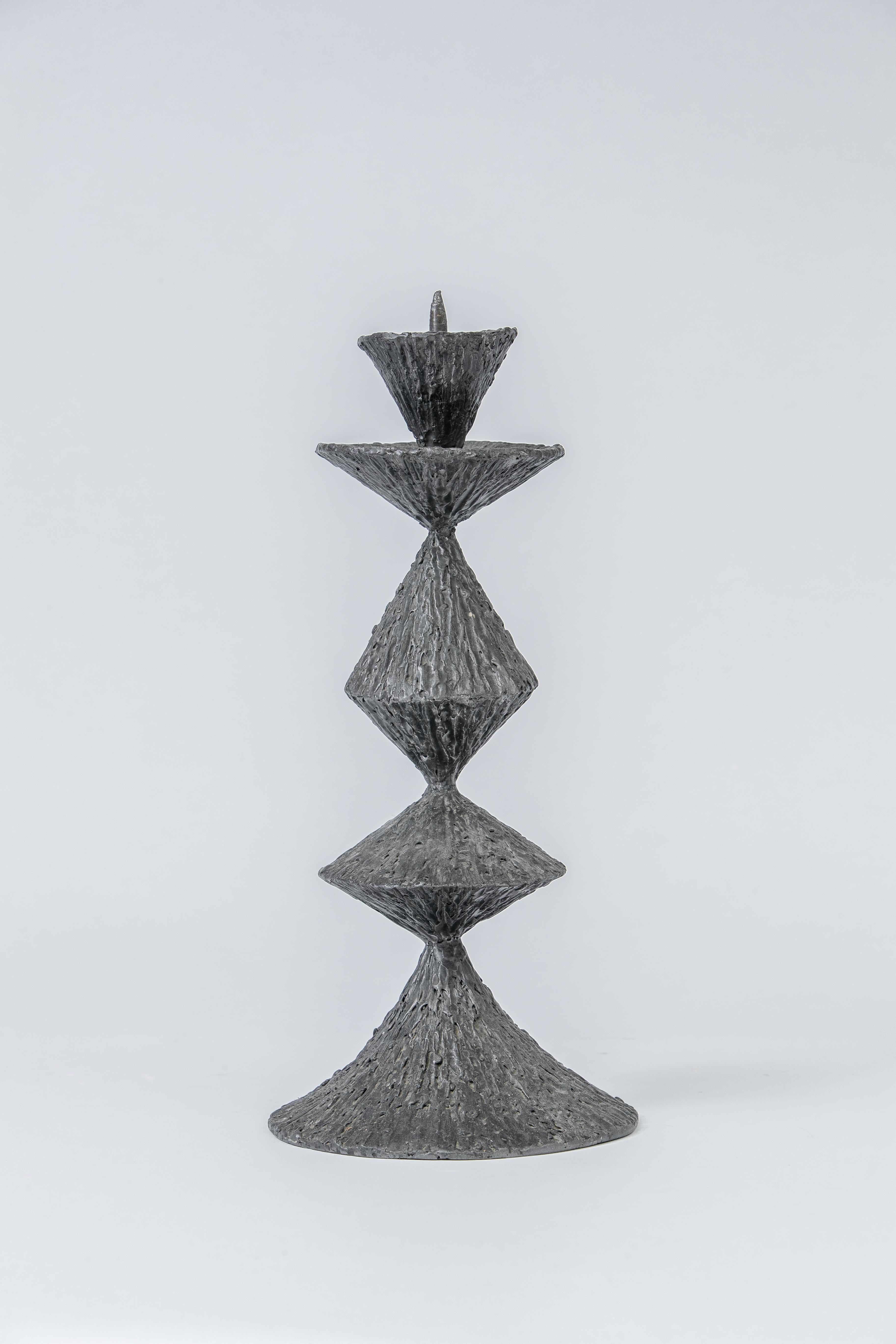 A large Brutalist candlestick in pewter, reminiscent of Giacometti's work, its surface mimics candle drips.