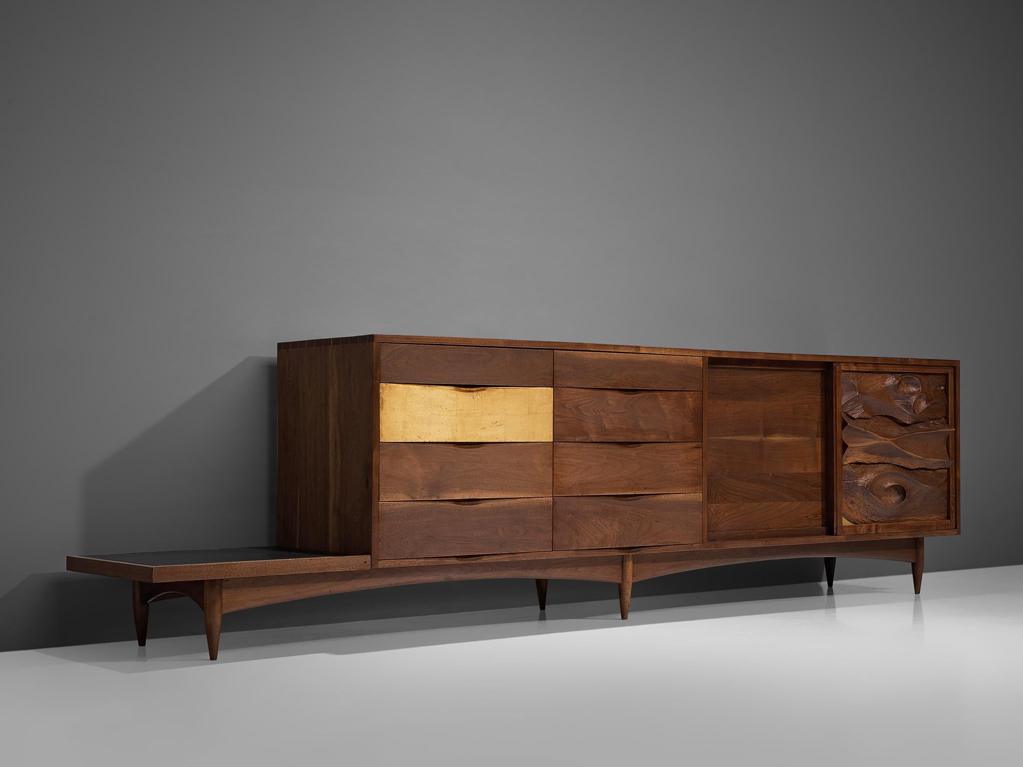 Phillip Lloyd Powell, cabinet, American black walnut, giltwood and slate, New Hope, United States, early 1960s.

This exquisite large sideboard is designed by Phillip Lloyd Powell and executed in solid black walnut. The cabinet consists of four