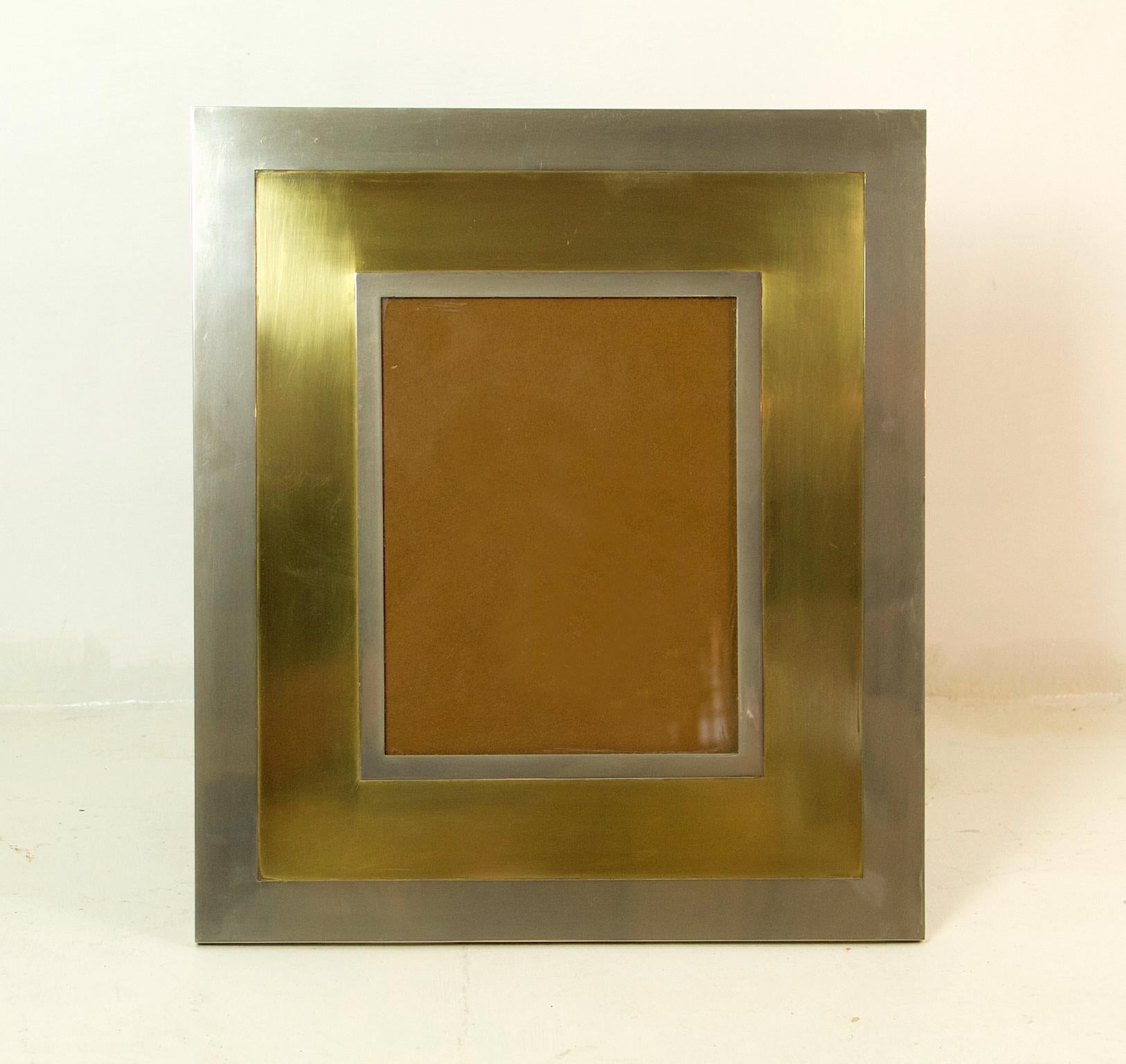 A very large picture frame from the 1970s made in brass and steel made to be standing.