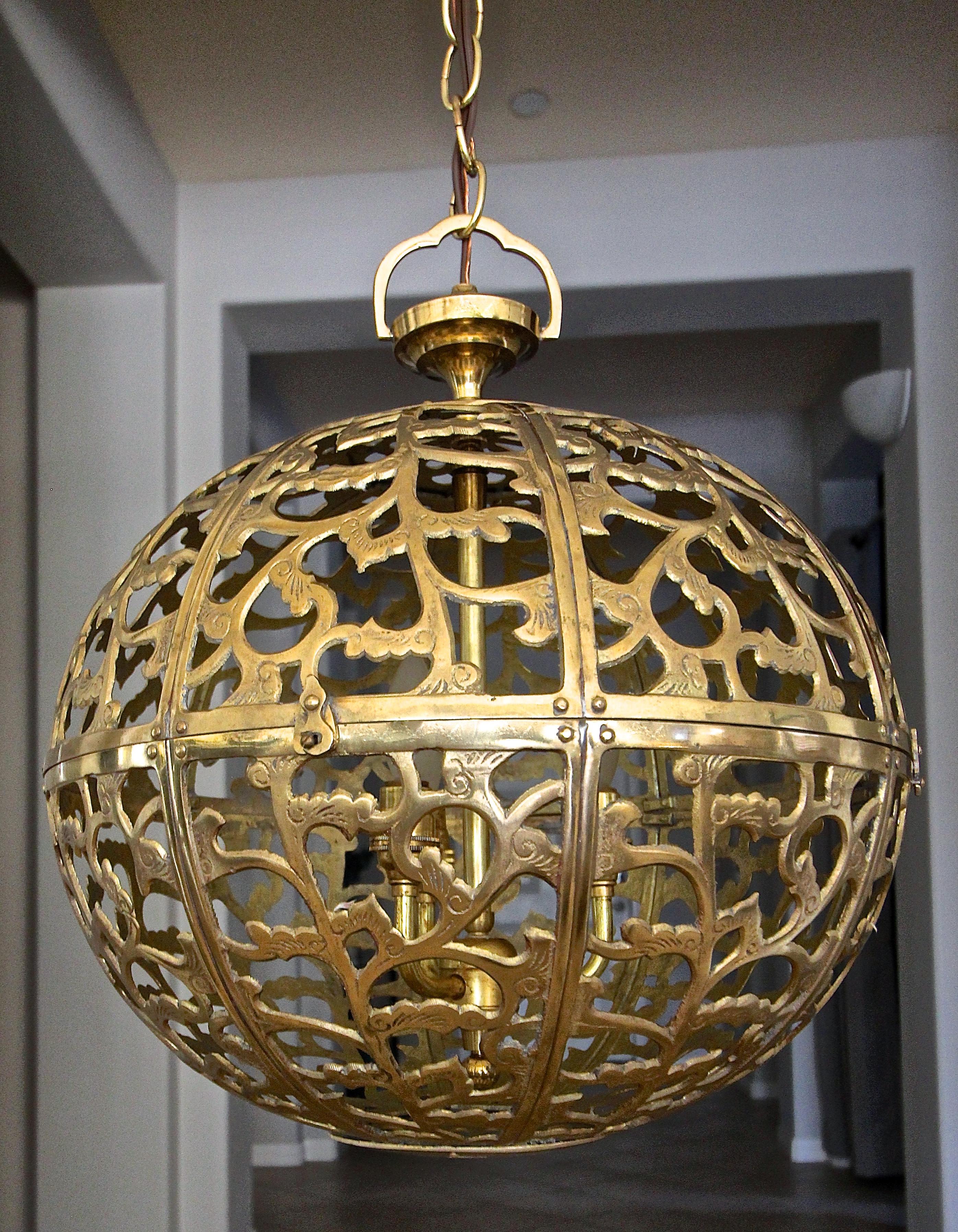 Brass pierced Asian chandelier or pendant light with scrolling arabesque pattern motif. Handcrafted from thick solid brass in Japan in the 1950s, this pendant has been refitted with a custom brass 3-light cluster for a more contemporary appeal.