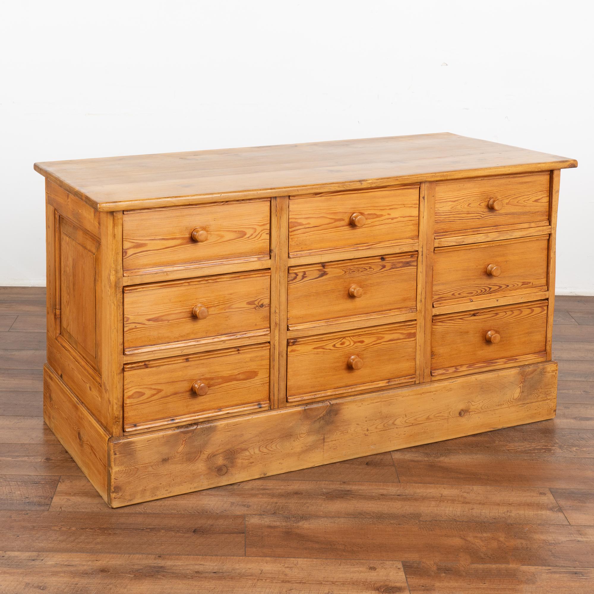 Fun and function combine in this pine chest of 9 drawers that likely originally served as a shop counter or storage cabinet. Counters similar to this were used throughout shops in European and are a great way to incorporate old world charm and