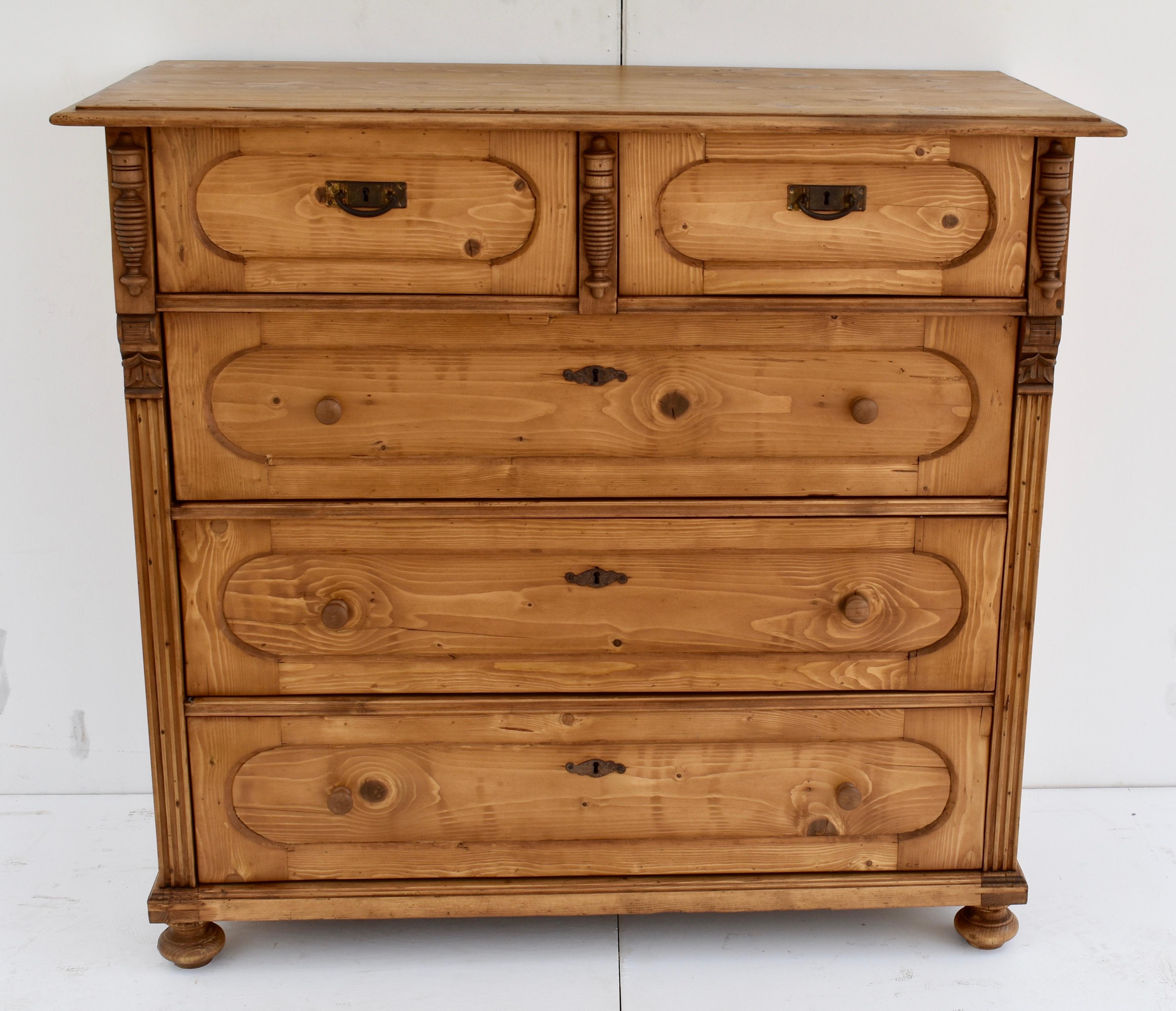 This very distinguished-looking chest of drawers has a step down edge to the top above five oval-paneled hand-cut dovetailed drawers in a two over three configuration. The top drawers Stand slightly proud of the face of the piece and are flanked and